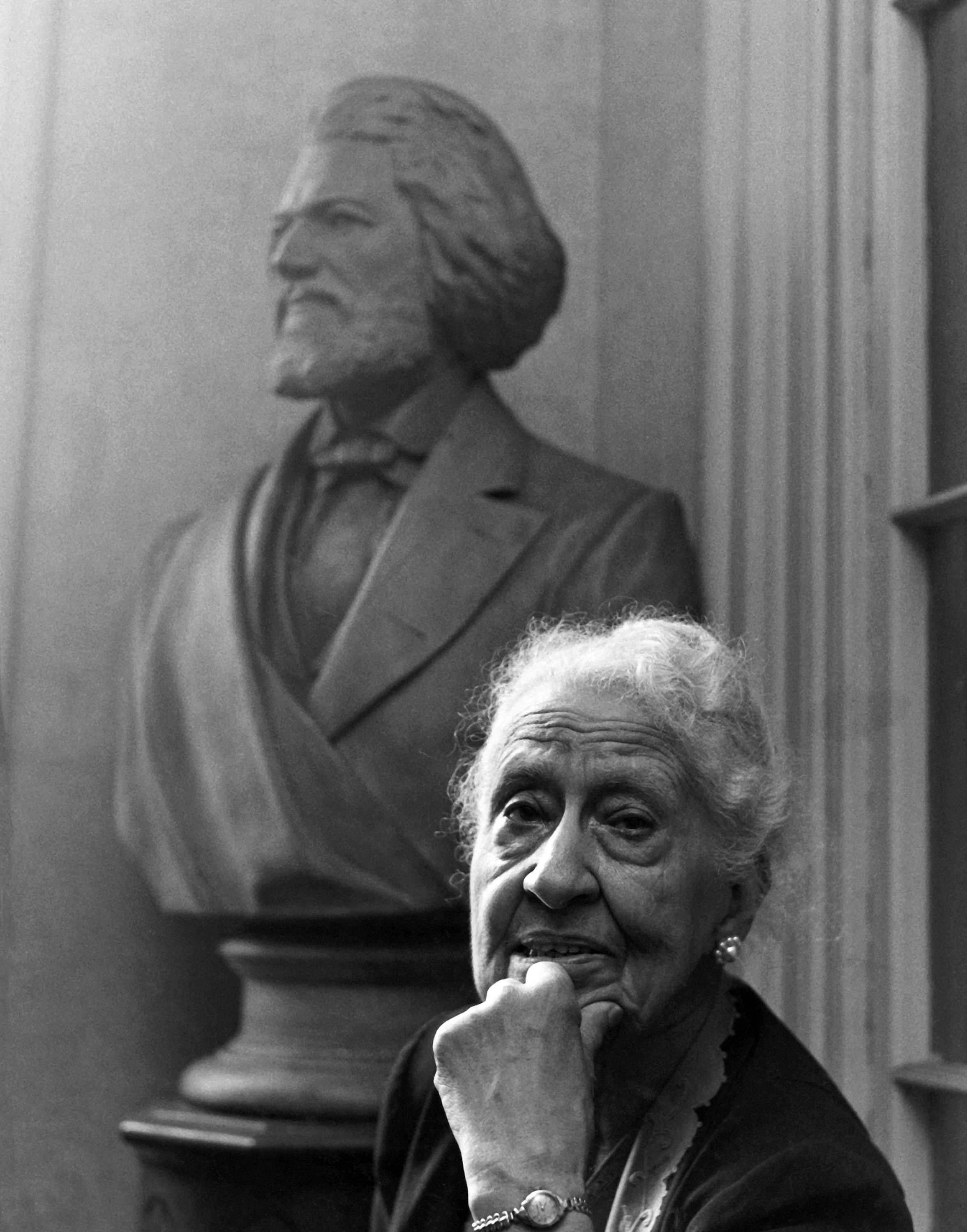 Black and white photograph of Mary Church Terrell in front of bust of Frederick Douglass