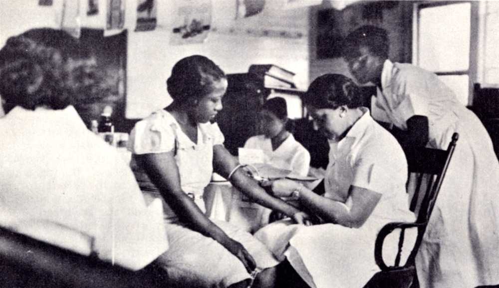Photograph of Dr. Dorothy Ferebee gives blood test to woman