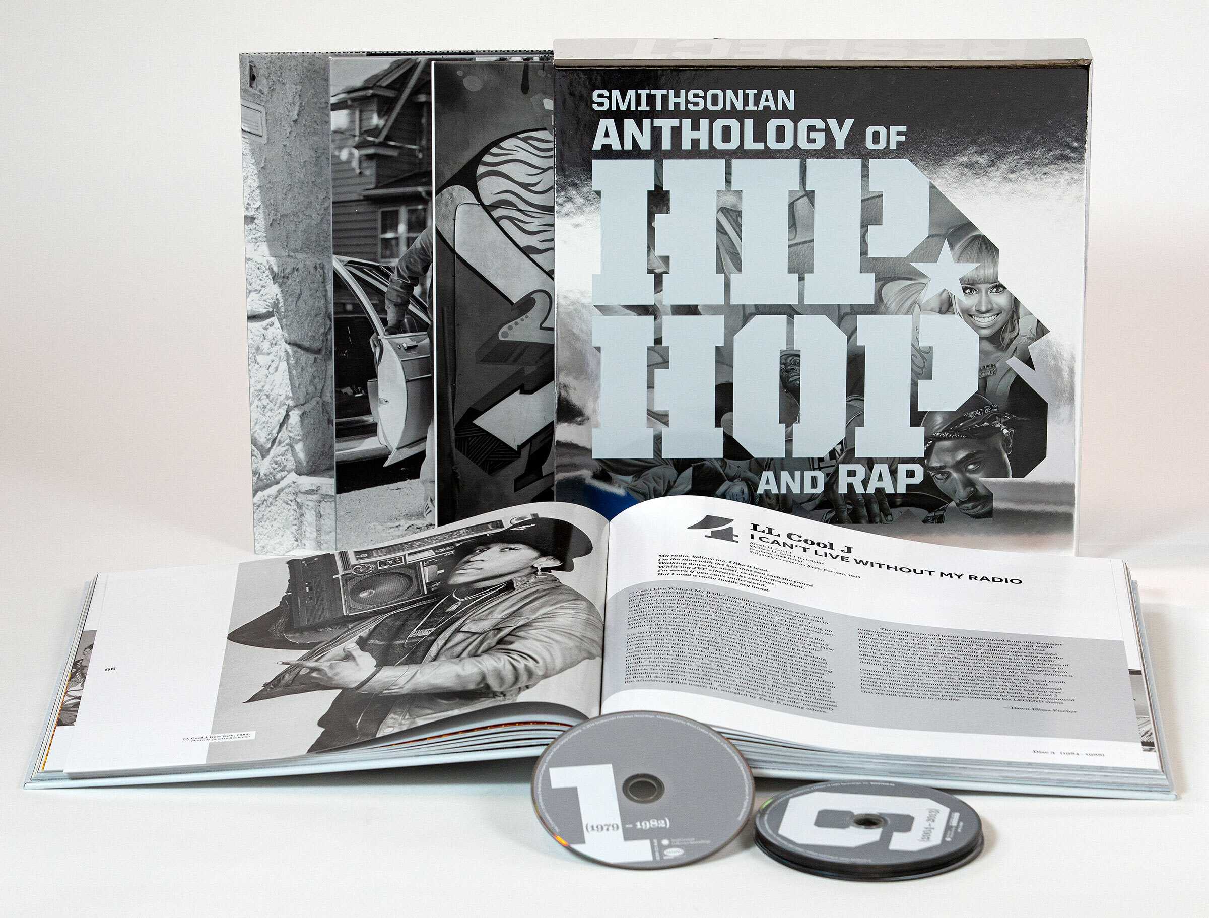 Black and white image of open book with CDs