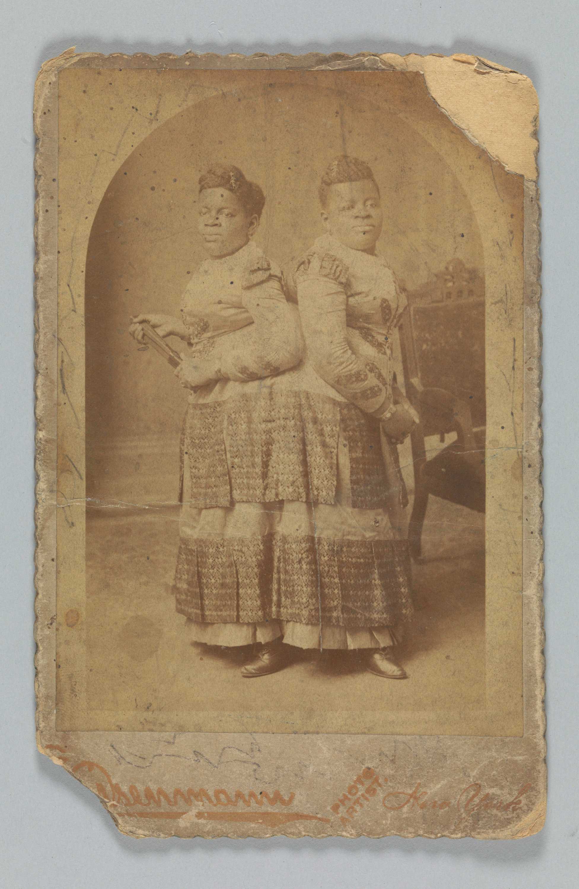 Image of a photograph of conjoined women Millie and Christine McCoy. The photograph is around the edges.