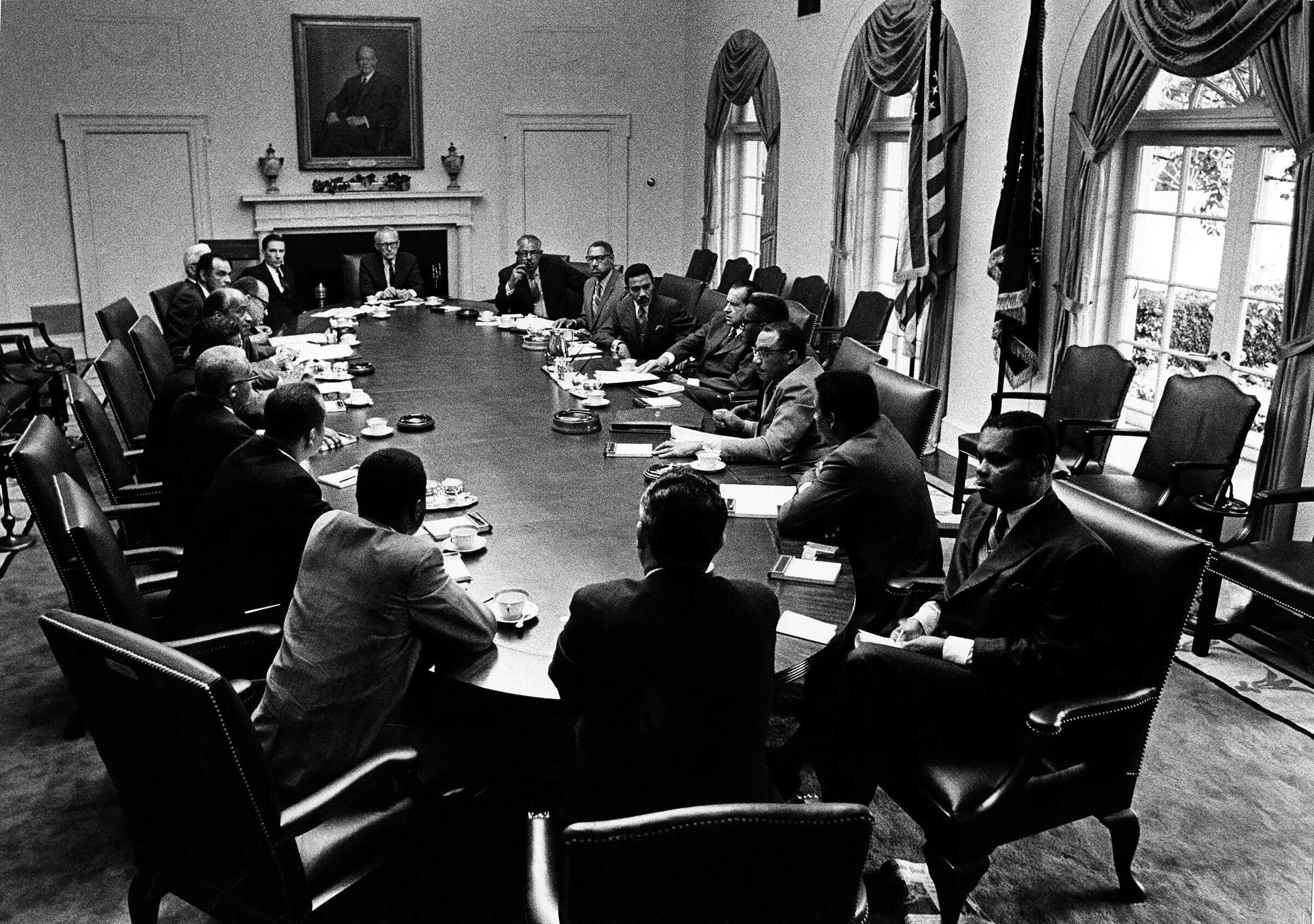 A photo of President Nixon meeting with a group of people.