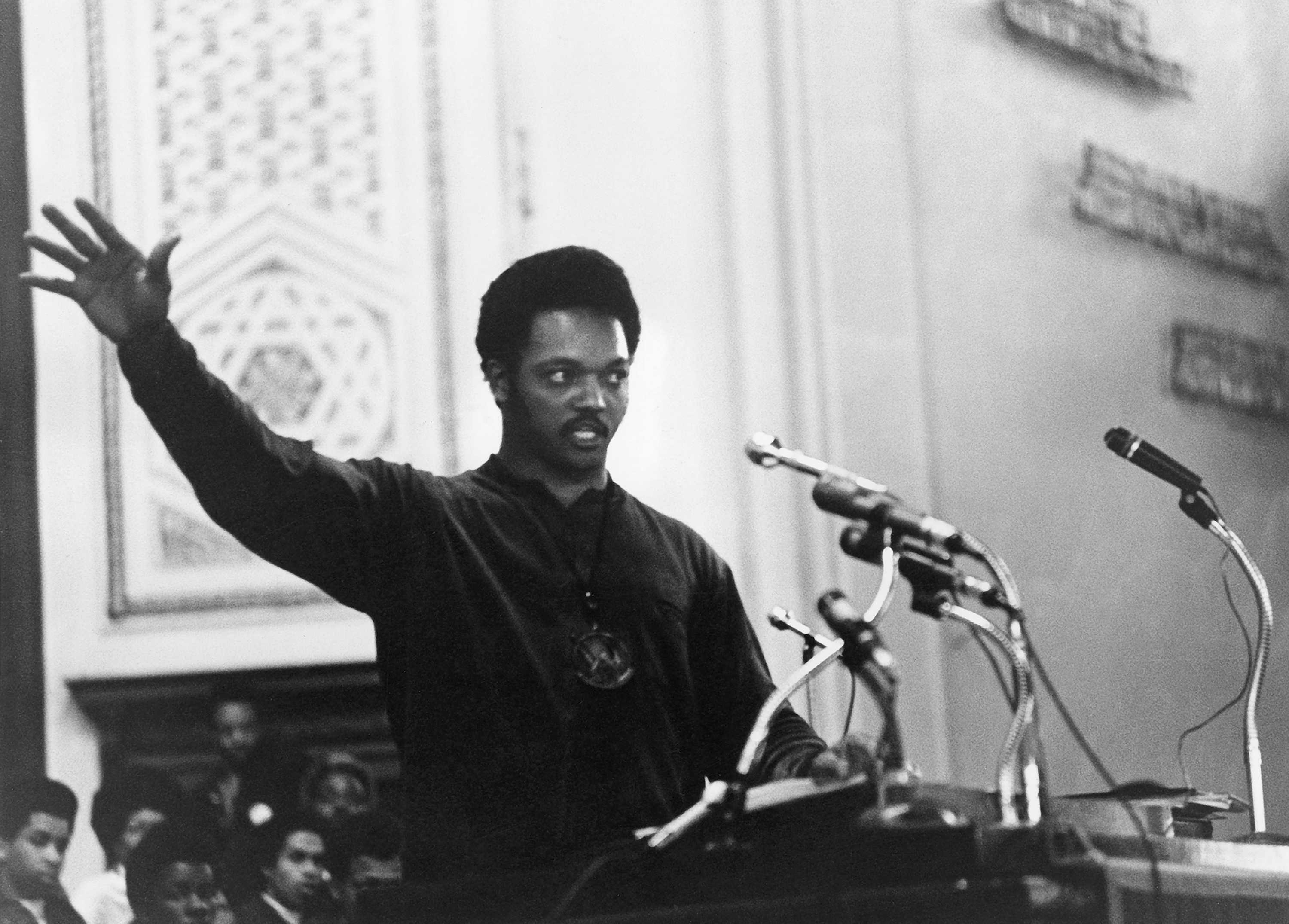 Photograph of Rev. Jesse Jackson speaking at a podium