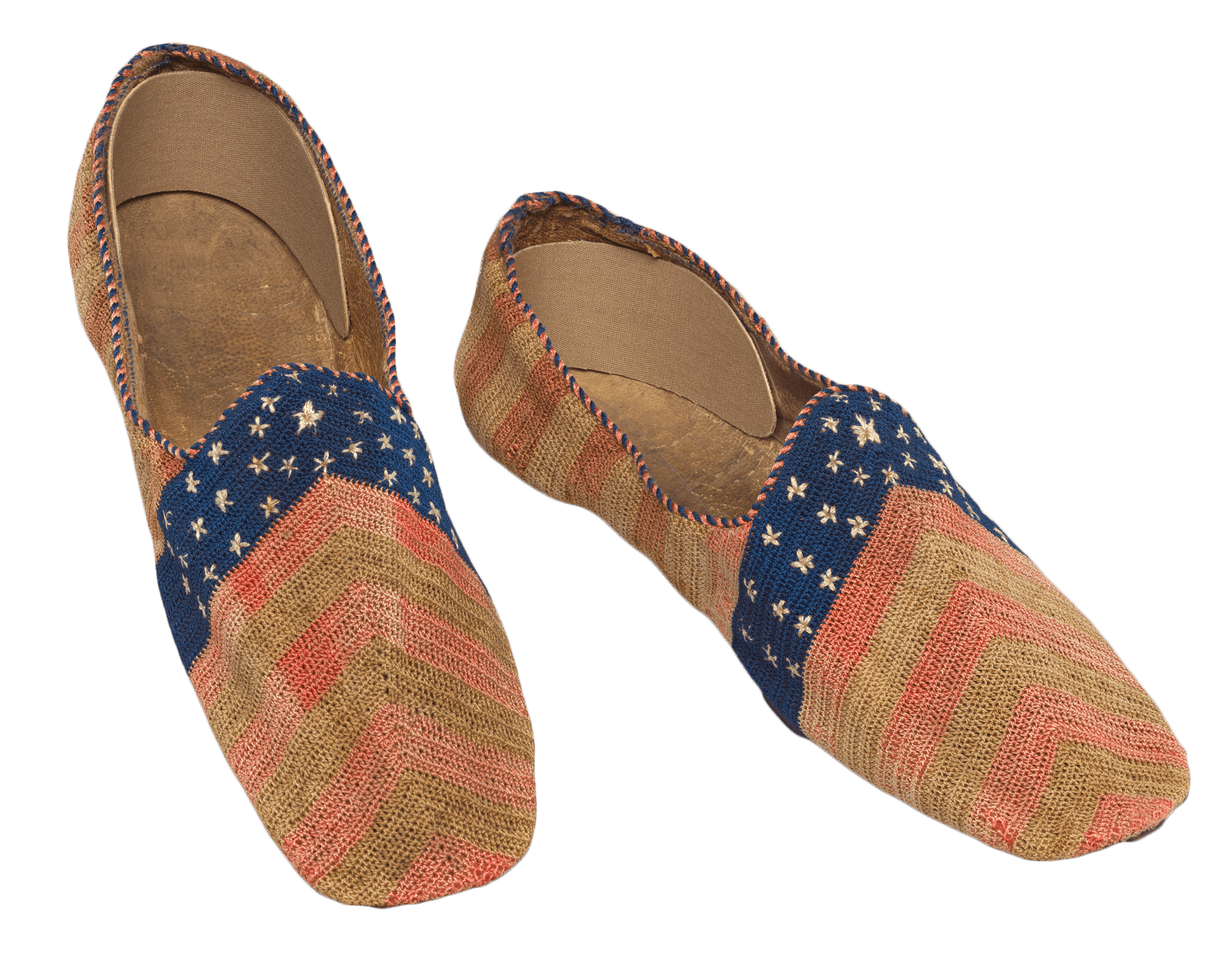 A pair of stars and stripes hand-woven slippers. The red and green chevron pattern is faded.