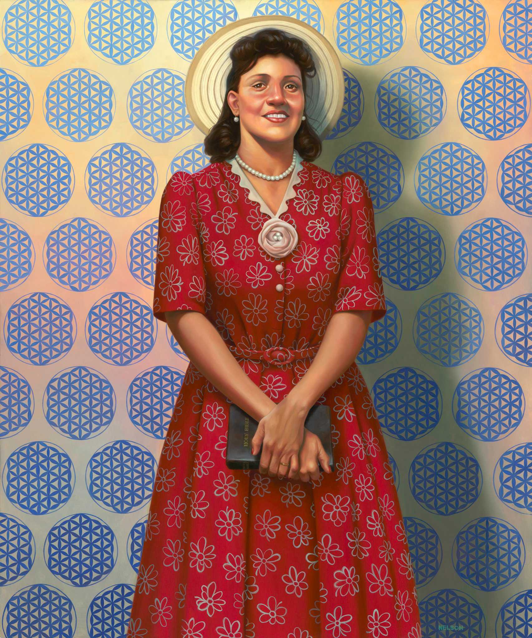 Oil painting of Henrietta Lacks by Kadir Nelson. Lacks, smiling, is depicted standing in the center of the image. She is facing forward with her hands clasped in front of her body, holding a black book with gold-colored text [HOLY BIBLE]. Lacks is wearing a red dress with a white flower pattern and small belt. The dress has central buttons, with two (2) missing. There is a flower accessory with three (3) pearls in the center above the buttons. Lacks is wearing a wedding ring and a pearl necklaces and earrings. She has a cream and tan hat, the circular brim of which acts like a halo behind her head. Lacks is standing in front of a cream wall with a blue geometric "Flower of Life" motif. The work is signed in the lower right.