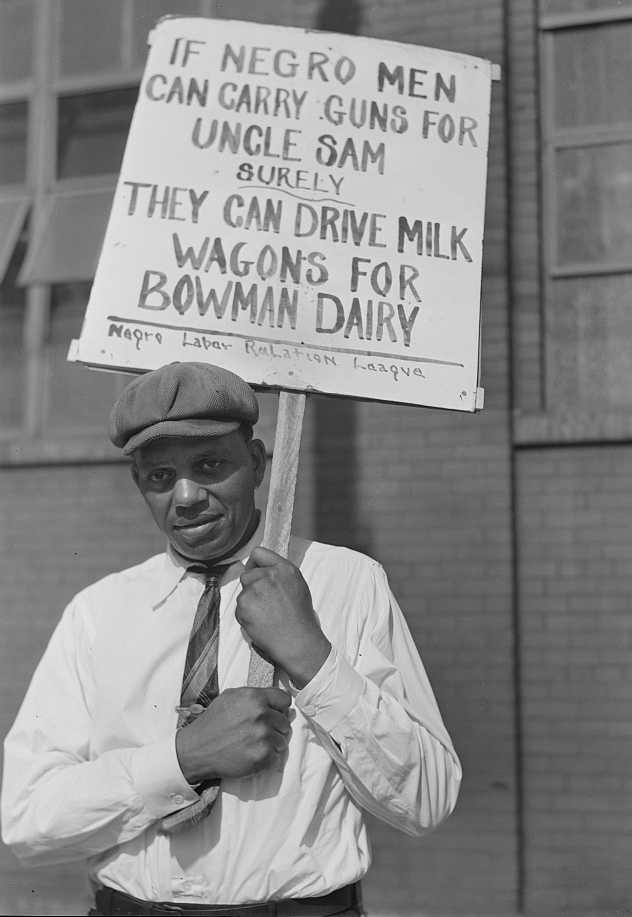 Photograph of man with protest sign