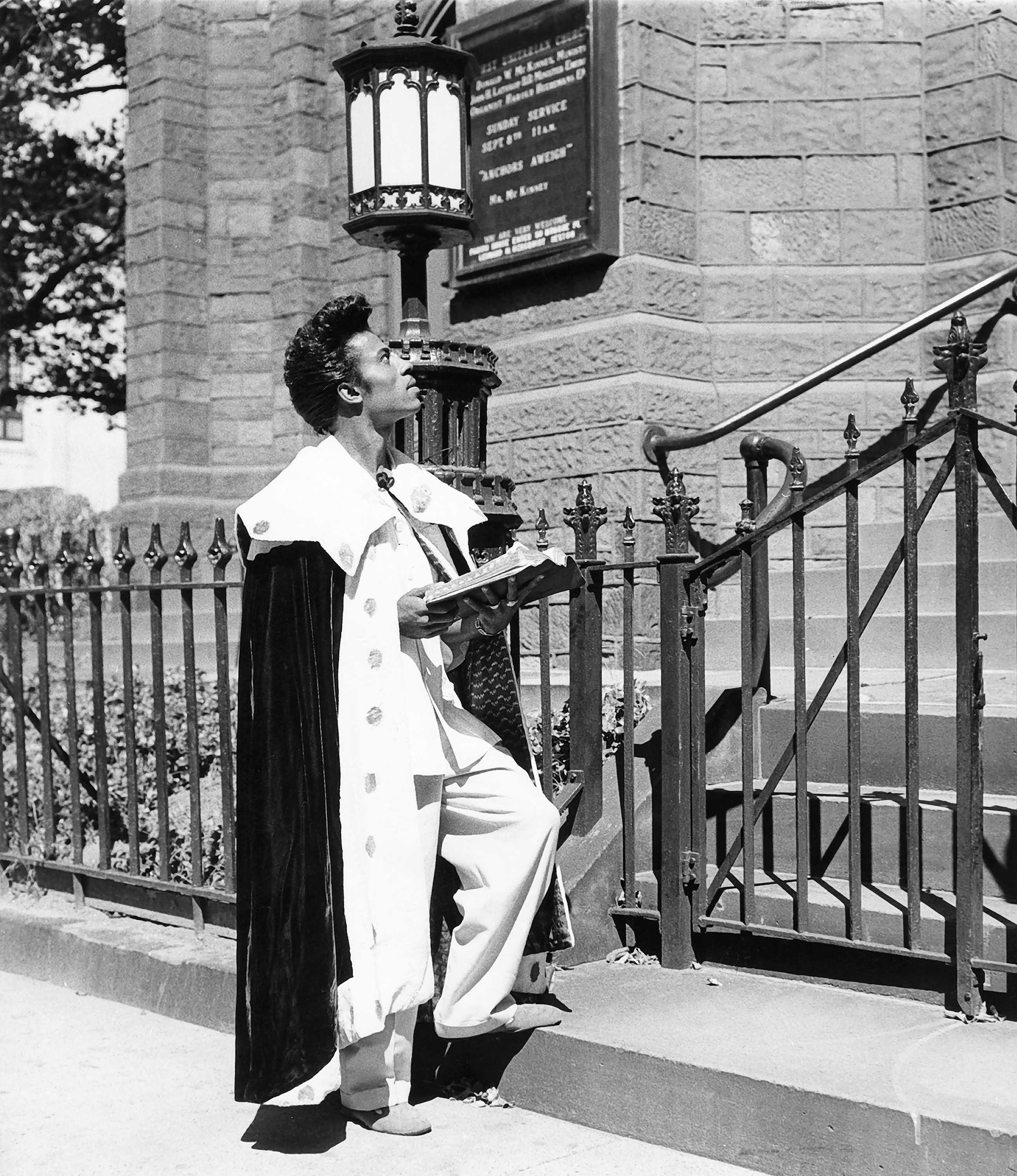 Black and white photograph of Little Richard praying on the steps of First Unitarian Church