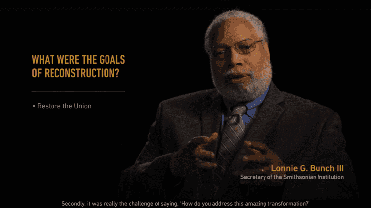 Lonnie Bunch III explaining the goals of reconstruction against a black screen.