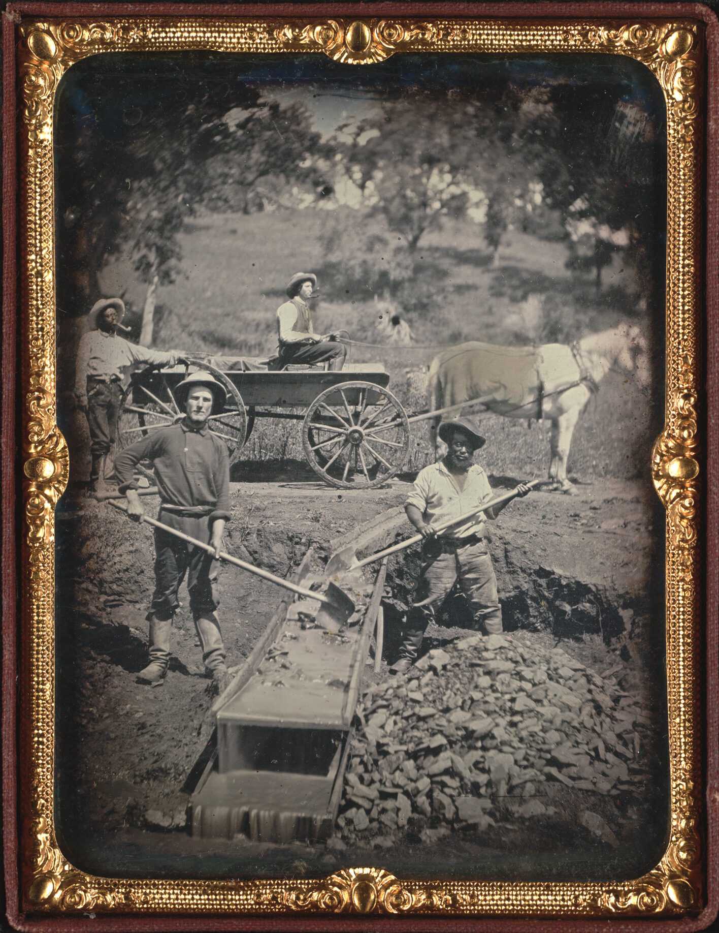 Black and white photograph of men mining gold