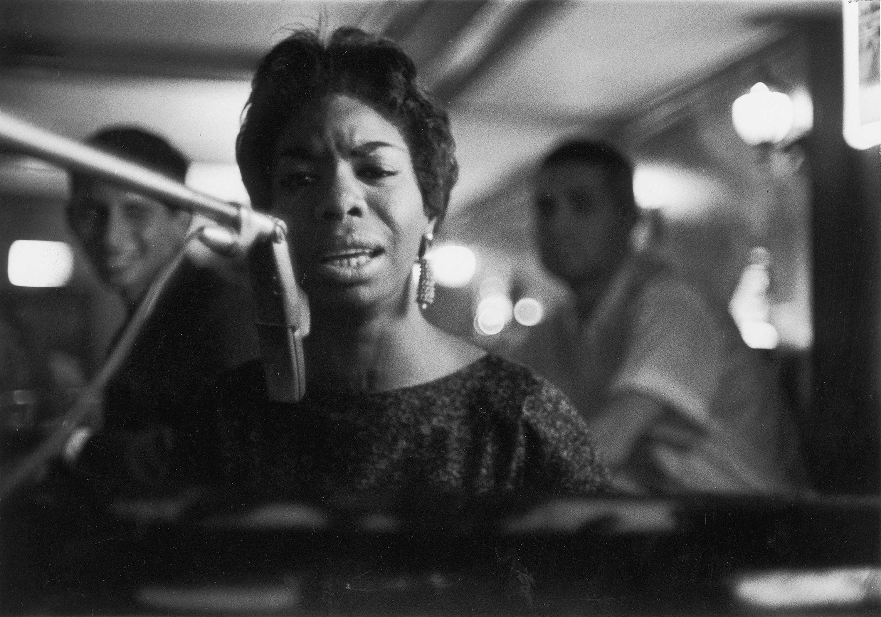 Close up photograph of Nina Simone singing in black and white
