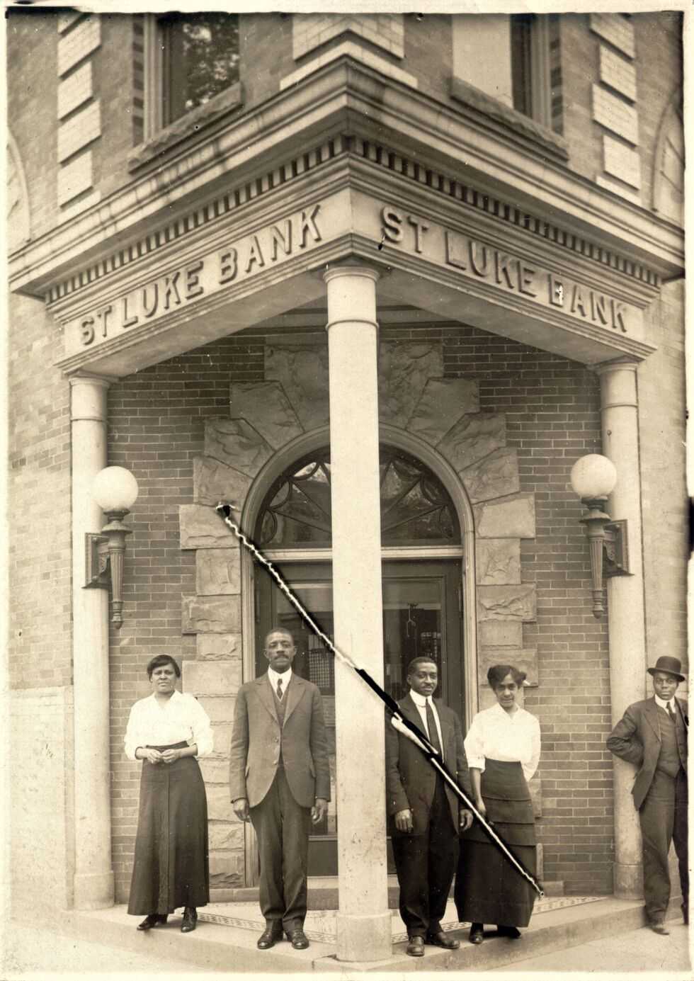 Photograph of employees at the entrance St Luke Bank