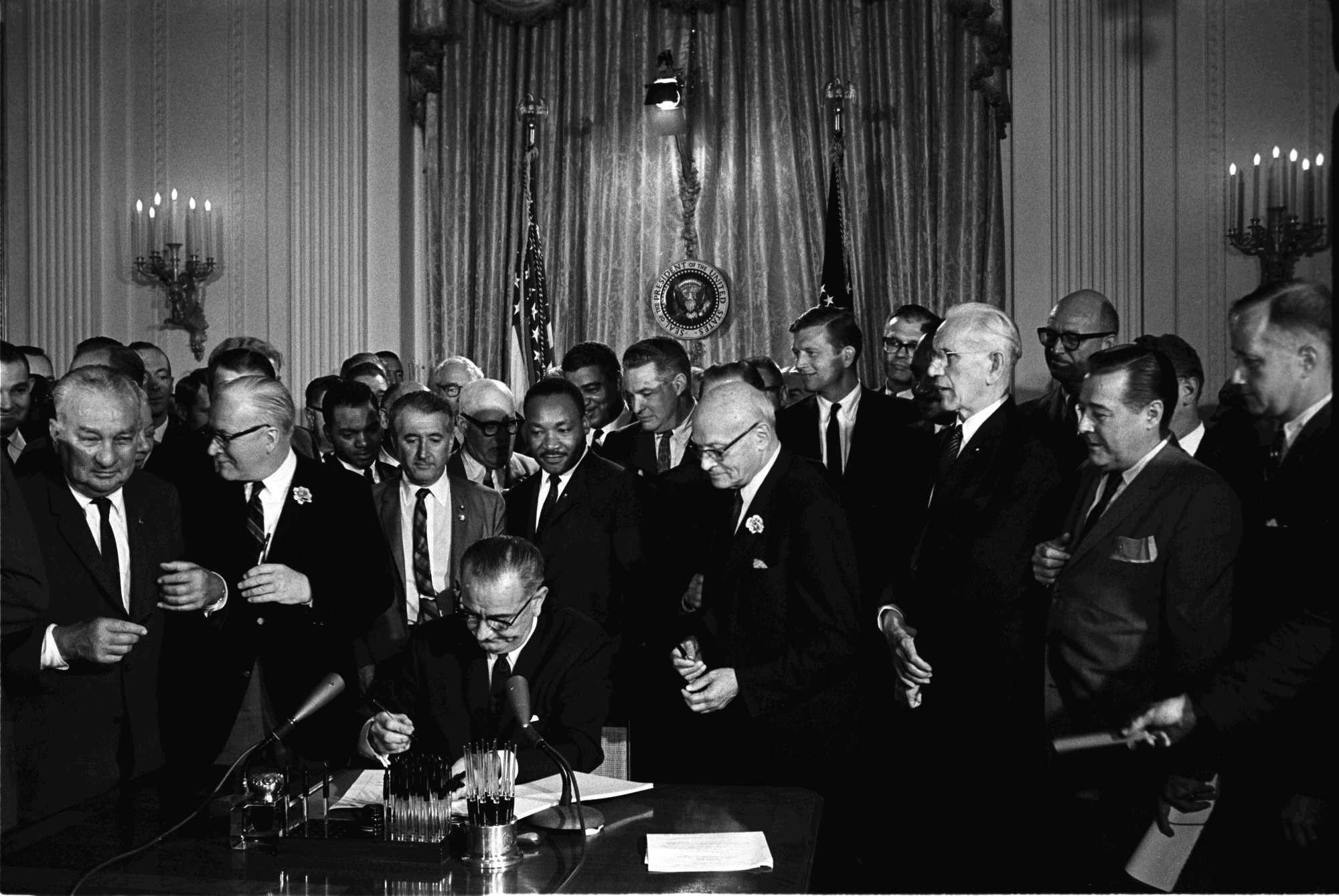 President Lyndon B. Johnson signs the 1964 Civil Rights Act