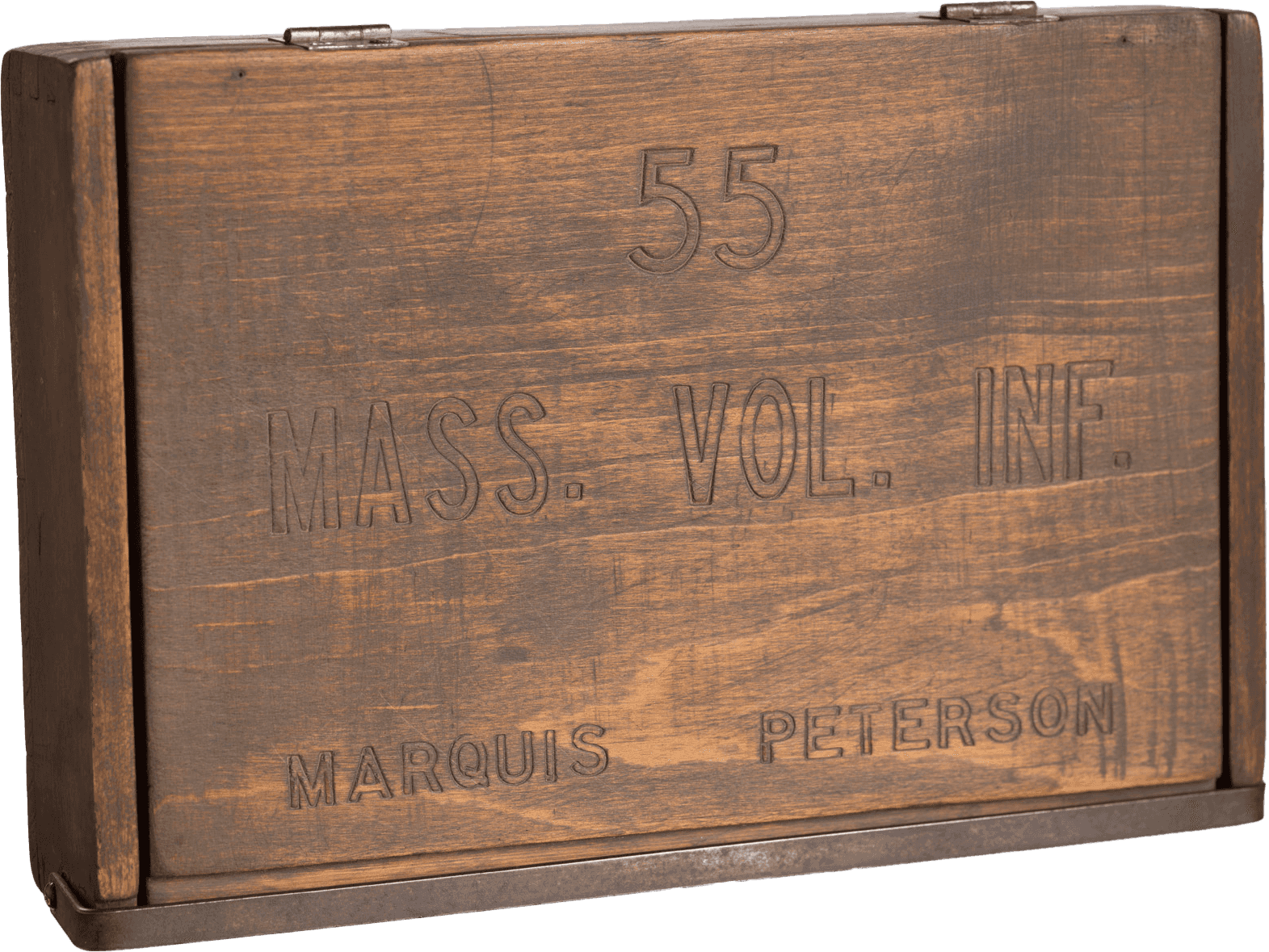 A wooden box owned by Marquis Peterson. The rectangular box is varnished brown and has a lid on top. Embossed on the lid is “55 / Mass. Vol. Inf. / Marquis Peterson.” The lid is connected to the box by two metal hinges. The sides of the box are constructed with dovetail joints and the bottom is nailed in place. A metal clasp runs the length of the box and secures the lid in place at front.