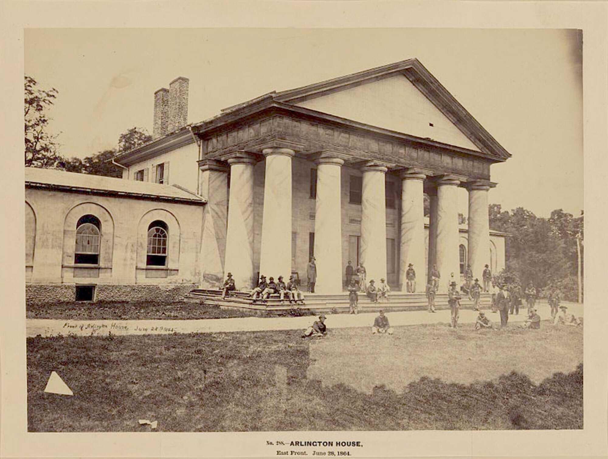 Photograph of Arlington House with people gathered on the steps and lawn, dated June 28, 1864.