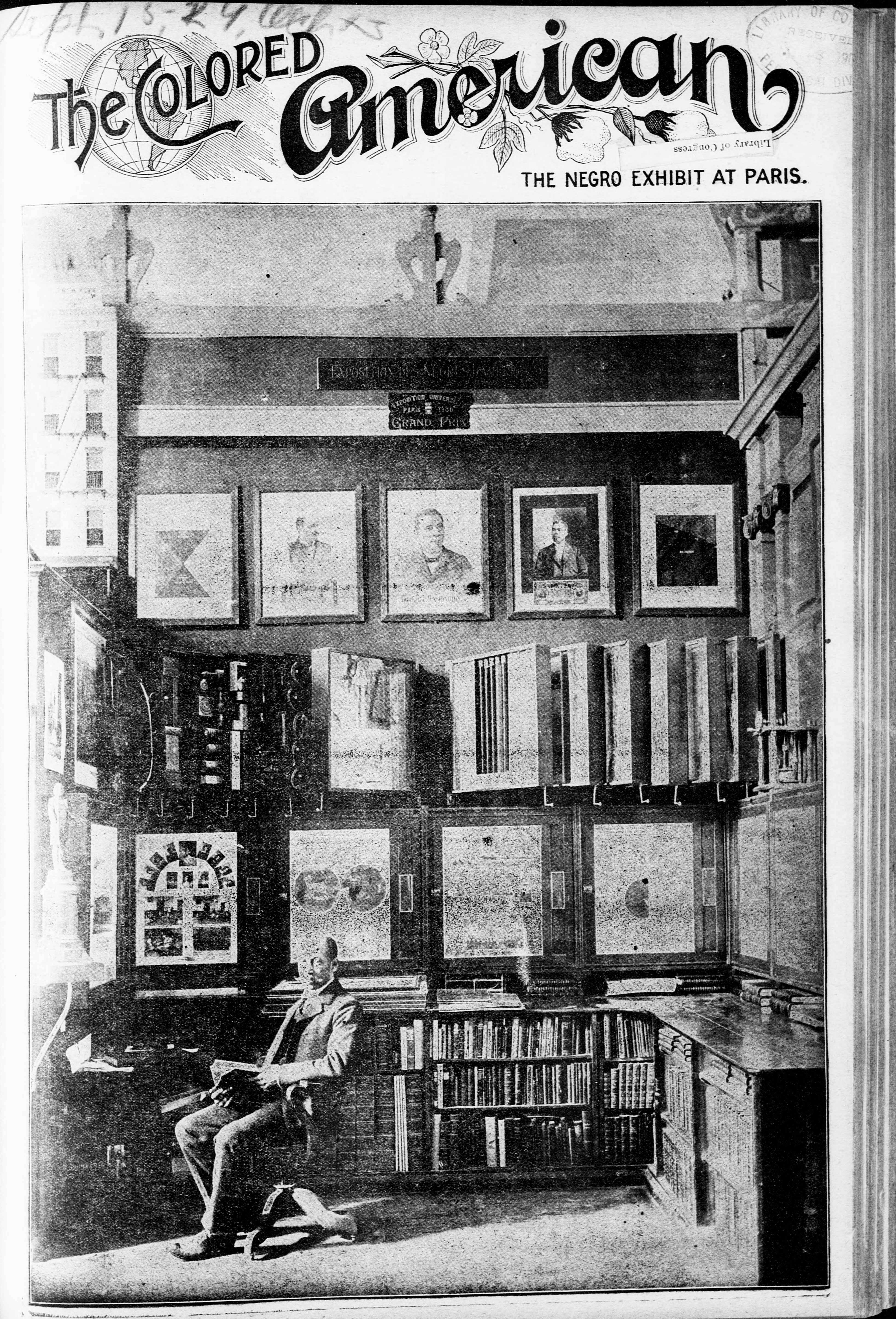 Black and white cover image of "The Colored American" periodical showing man sitting in chair in exhibition gallery.  Framed pictures hang on wall behind him as well as exhibition cases.  Book shelves filled with books are behind the man.