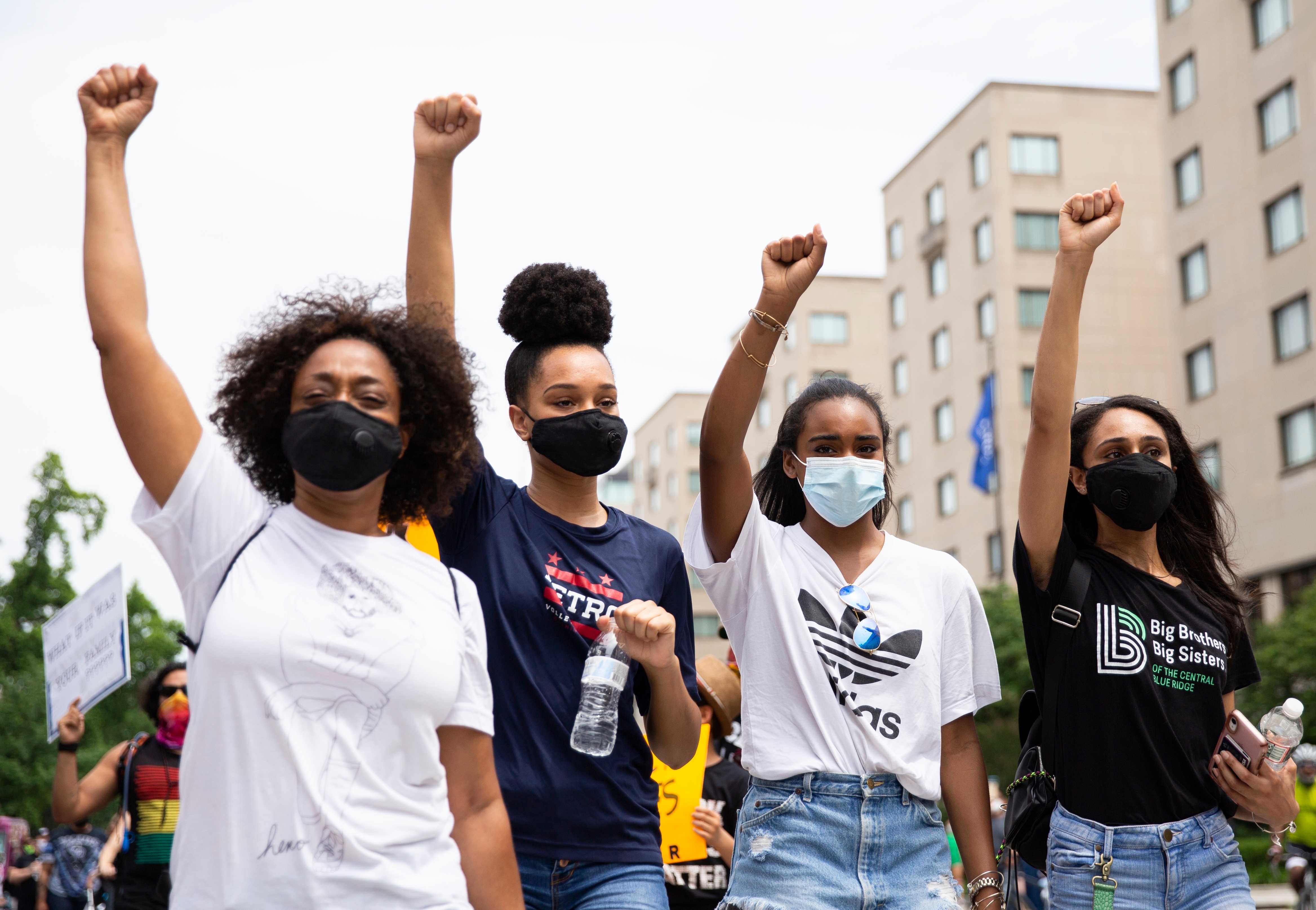 Black women in masks at a protest
