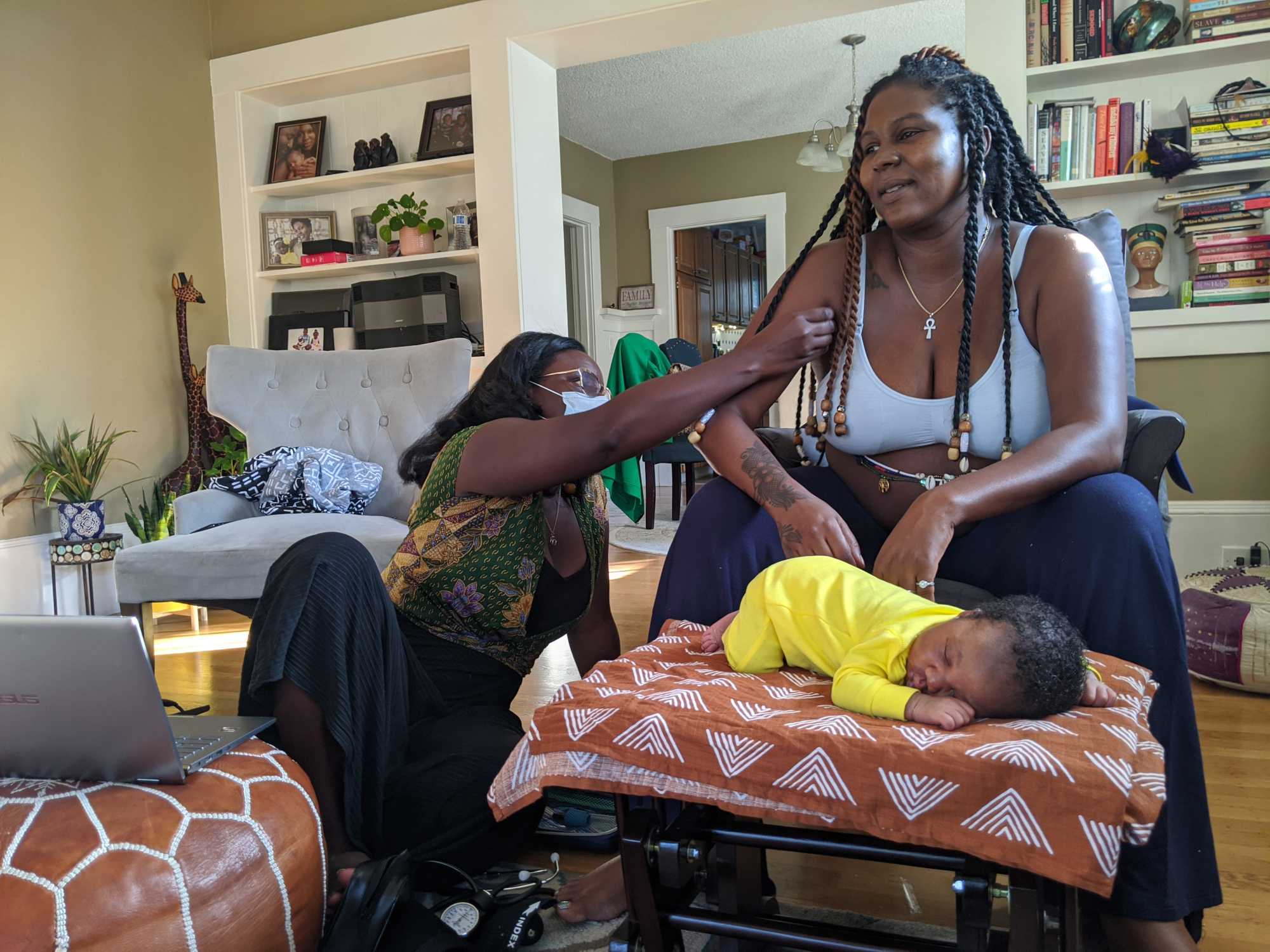 Midwife Kiki Jordan examines TaNefer Camara and her son
