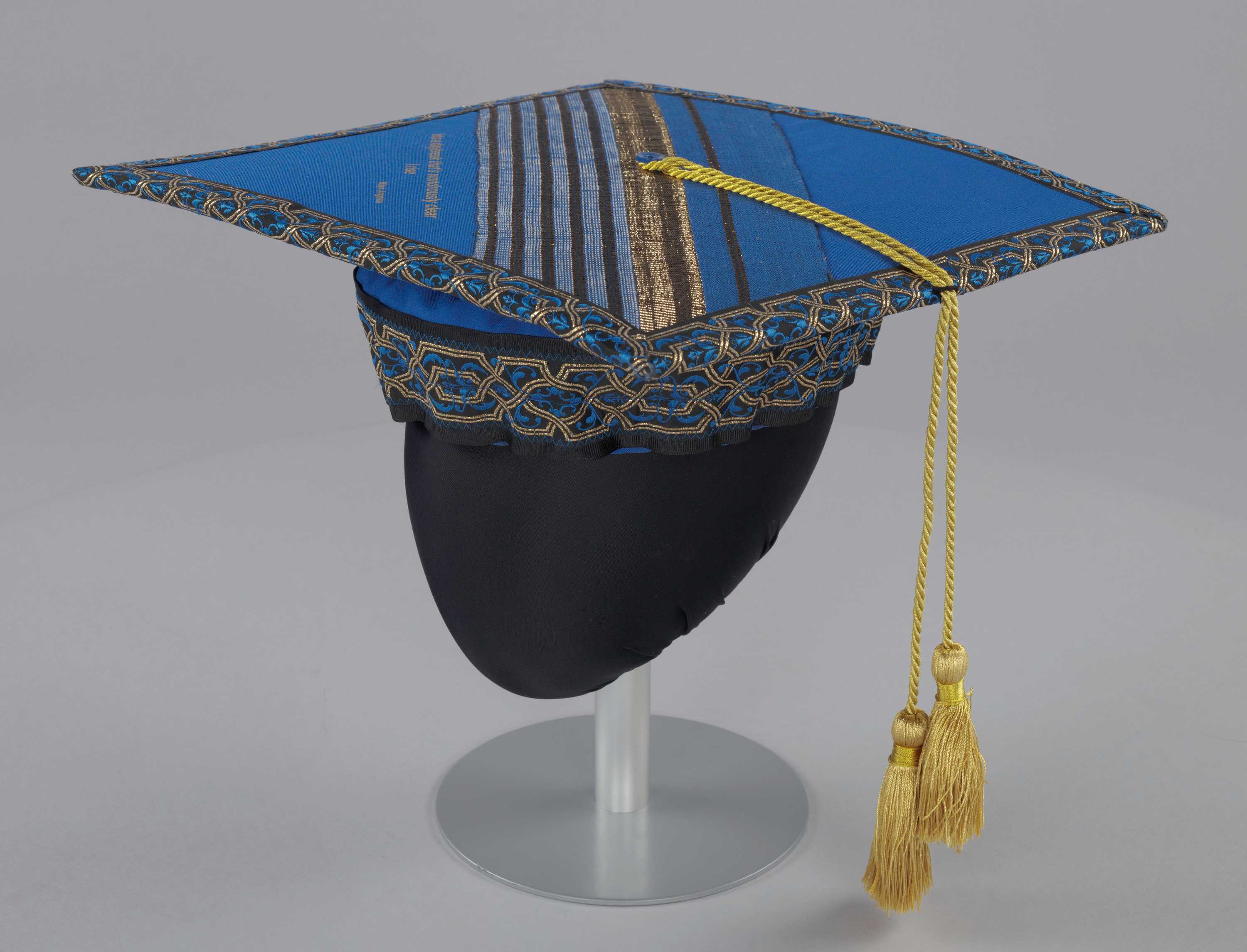 A blue and gold mortarboard cap from Bennett College worn by Dr. Johnnetta Betsch Cole.