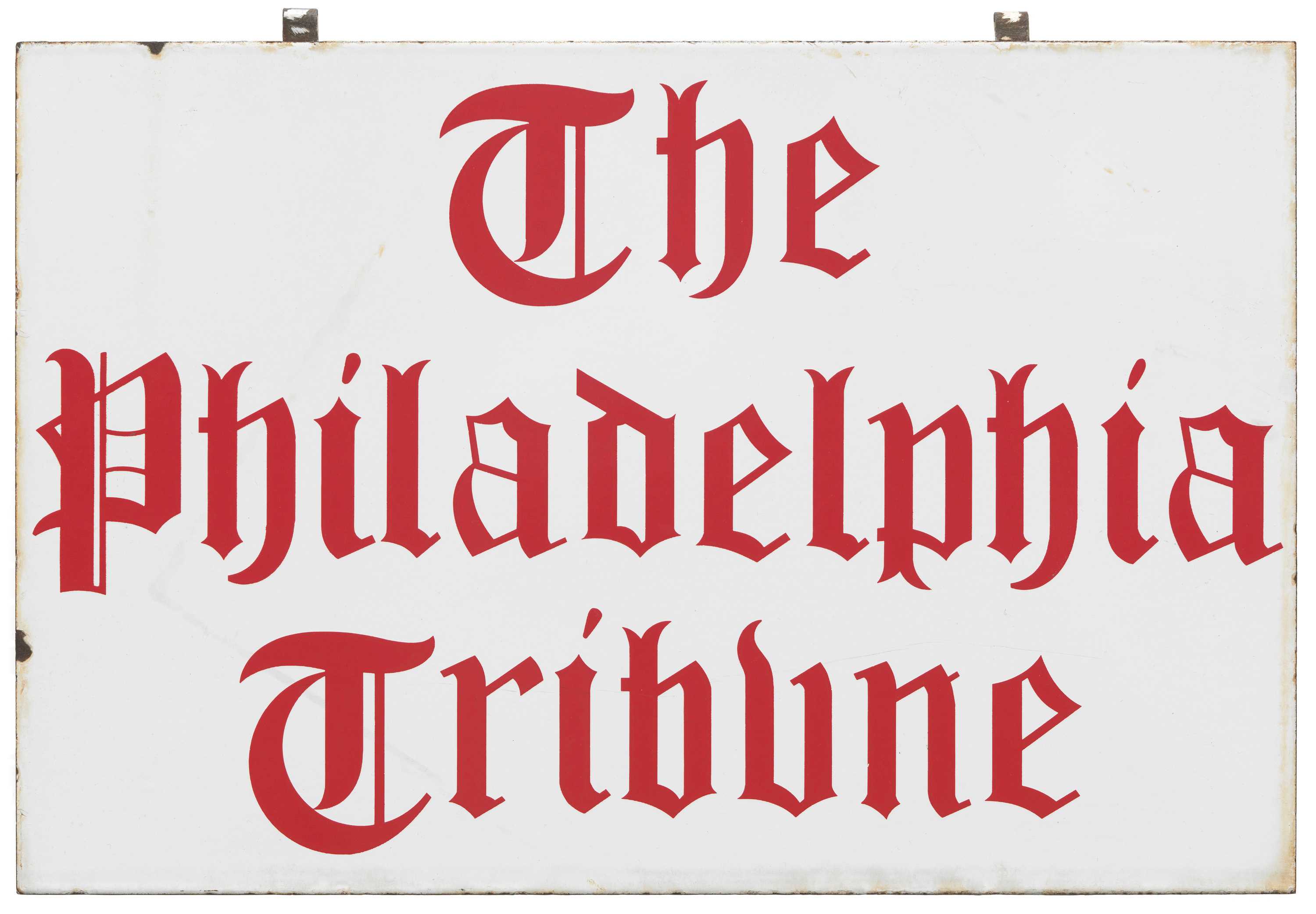 White porcelain covered metal sign with red lettering that reads [The / Philadelphia / Tribune].
