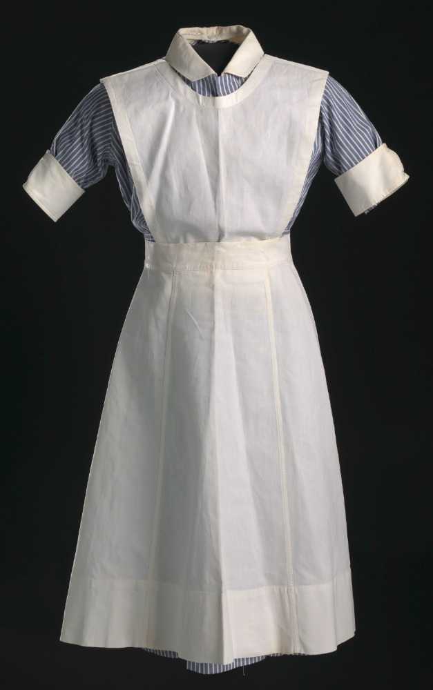 A blue-and-white striped nurse's uniform worn by Pauline Brown Payne. The dress has a button-up front and detachable white collar and sleeve cuffs. The collar is attached to the neck of the dress with one button at the nape and the collars are attached with two buttons on the outside of the sleeve. The sleeves have the manufacturer's information stamped in black ink on the inside and the collar there are two names written in freehand. The dress is an A-line silhouette with a pocket at the PL breast and one on the PR hip. The stripes of the dress are vertical, except at the waist, where there is a horizontally cut band. There are white buttons above and below as well as at the waist. There is a manufacturer's and a personal tag sewn to the inside nape of the neck.