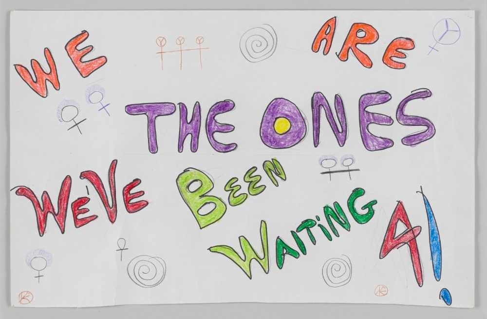 The poster is white with handwritten, block text that read, "We are / The Ones / We've been / Waiting / 4!".