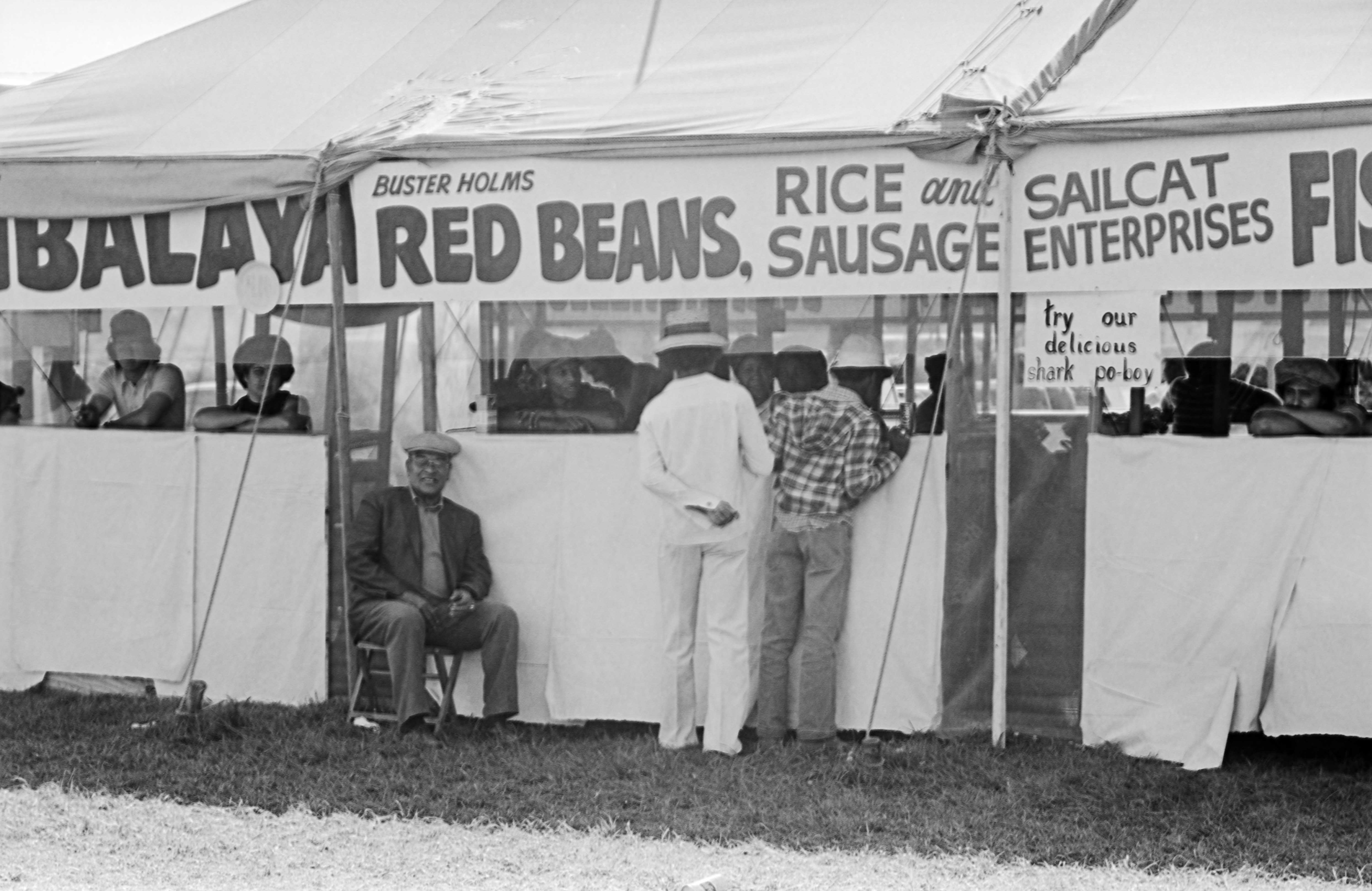 Black and white photograph of Buster Holmes' booth selling Red Beans, Rice and Sausage.