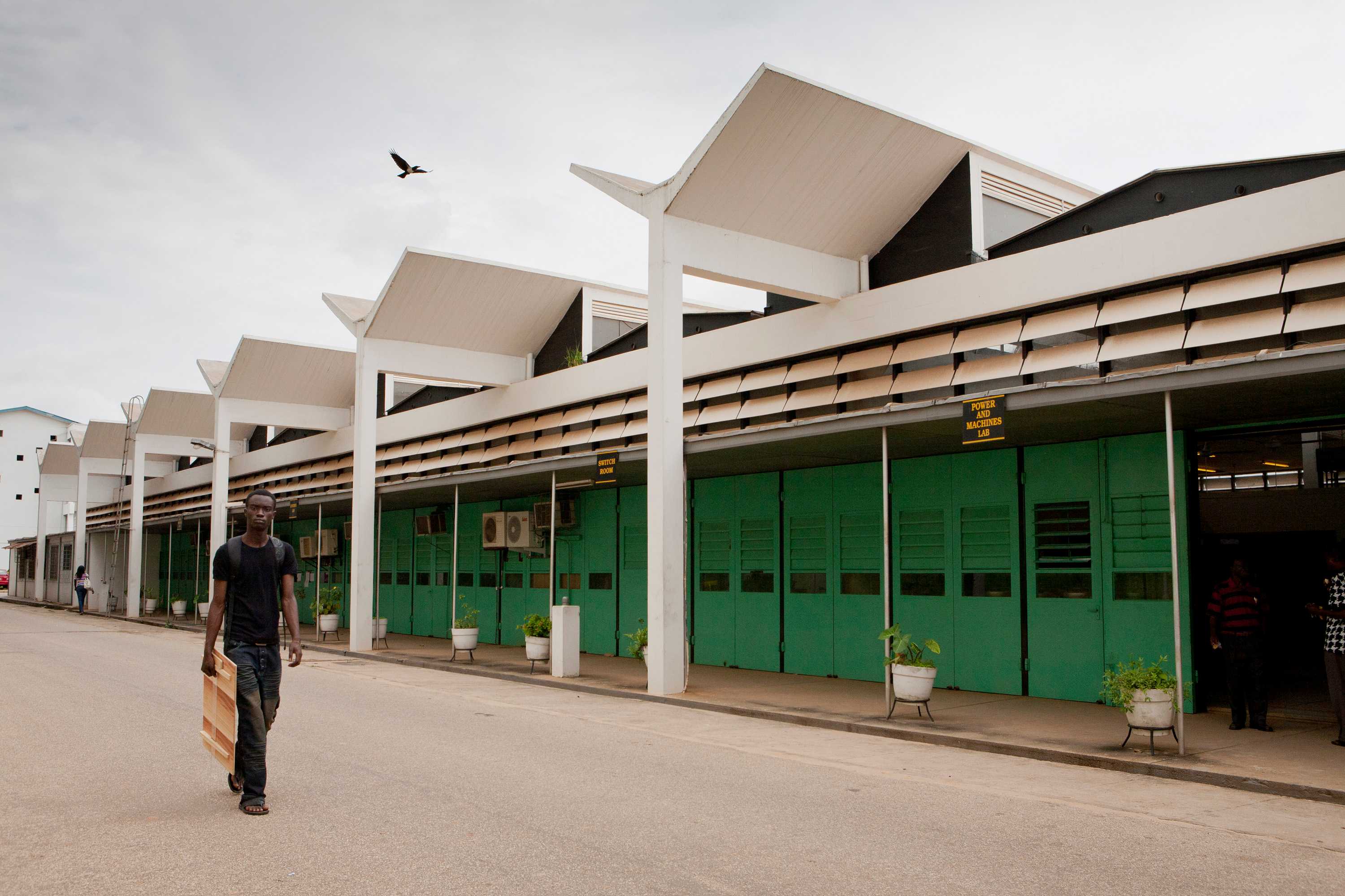 The School of Engineering at Kwame Nkrumah University of Science and Technology is one level building with bright green doors.
