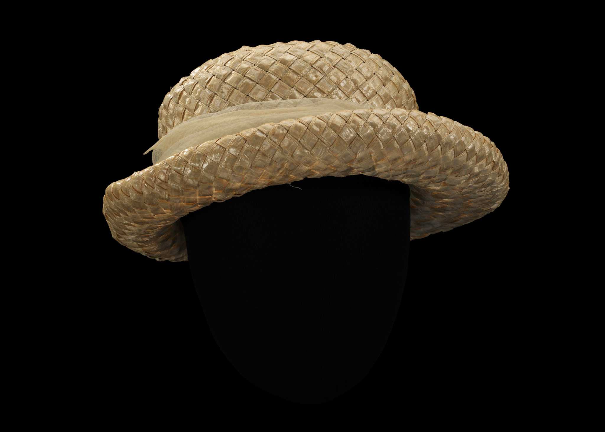 A light colored straw hat with a chiffon band has a gold, long and thin pin and was owned by Rosa Parks.