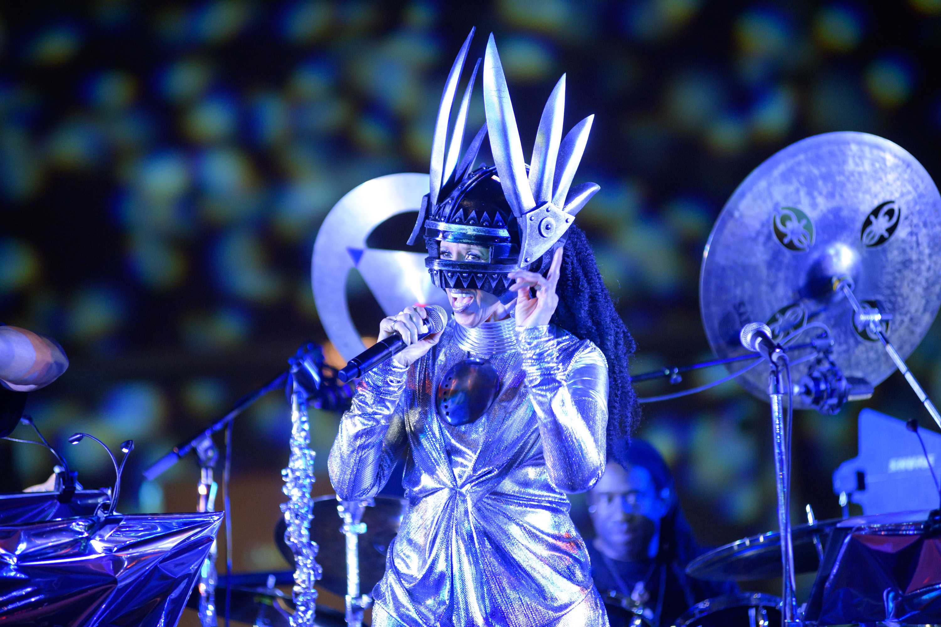 Hendryx preforming in a futurist sliver costume, which includes a sculpturally pointed helmet.