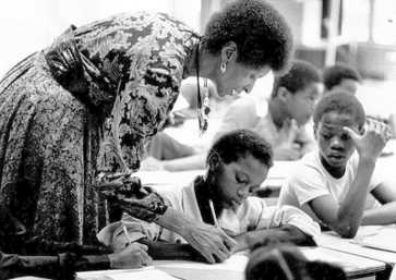 Black and white photograph of Marva Collins in a classroom with students