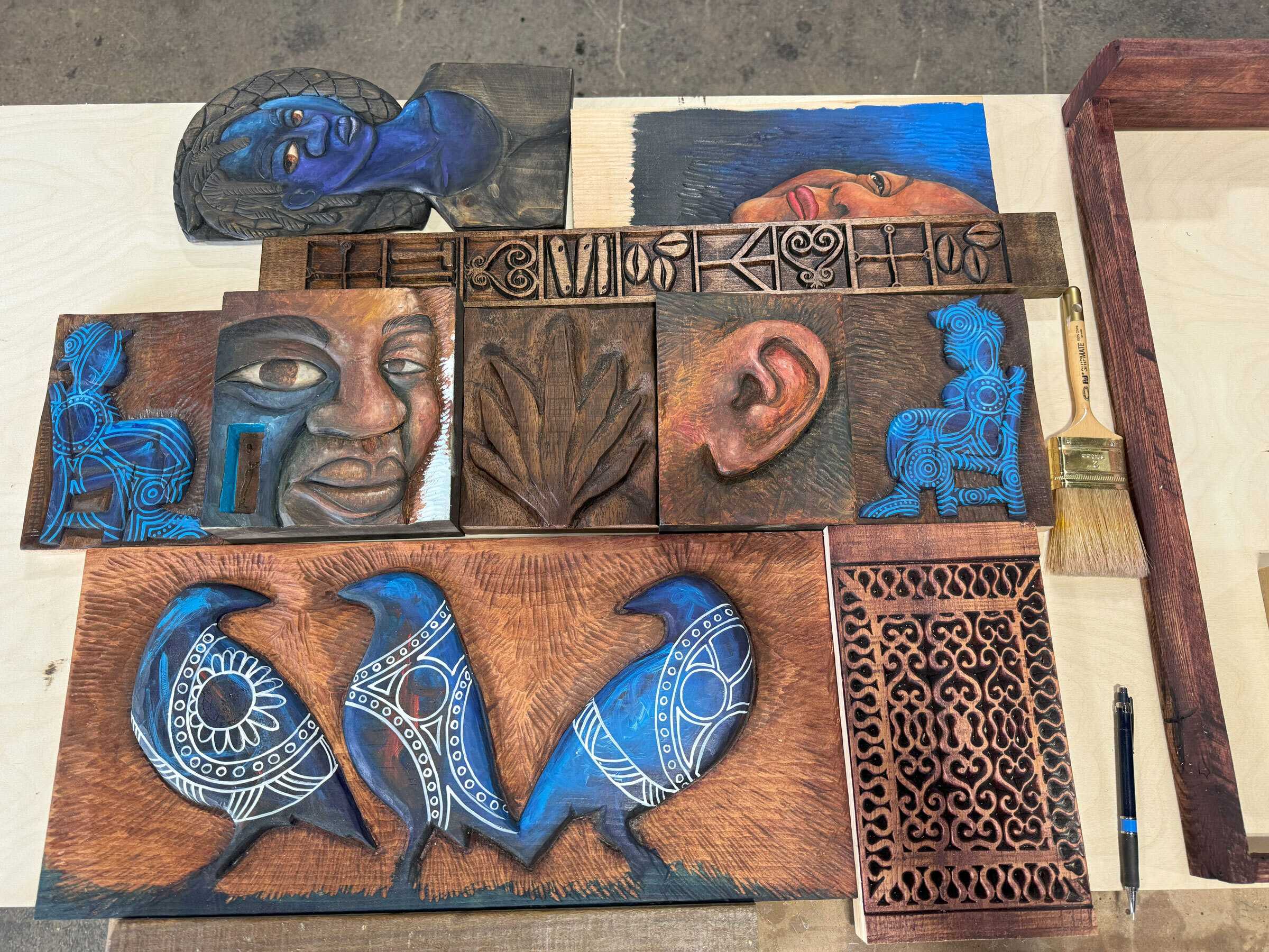 Color photograph of tiles pieced together on a table.
