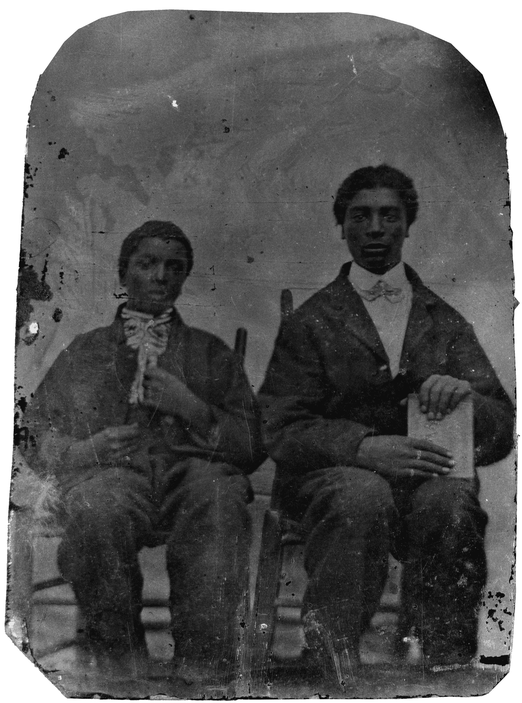 Black and White photograph of George Washington Carver and his brother Jim seated in chairs.