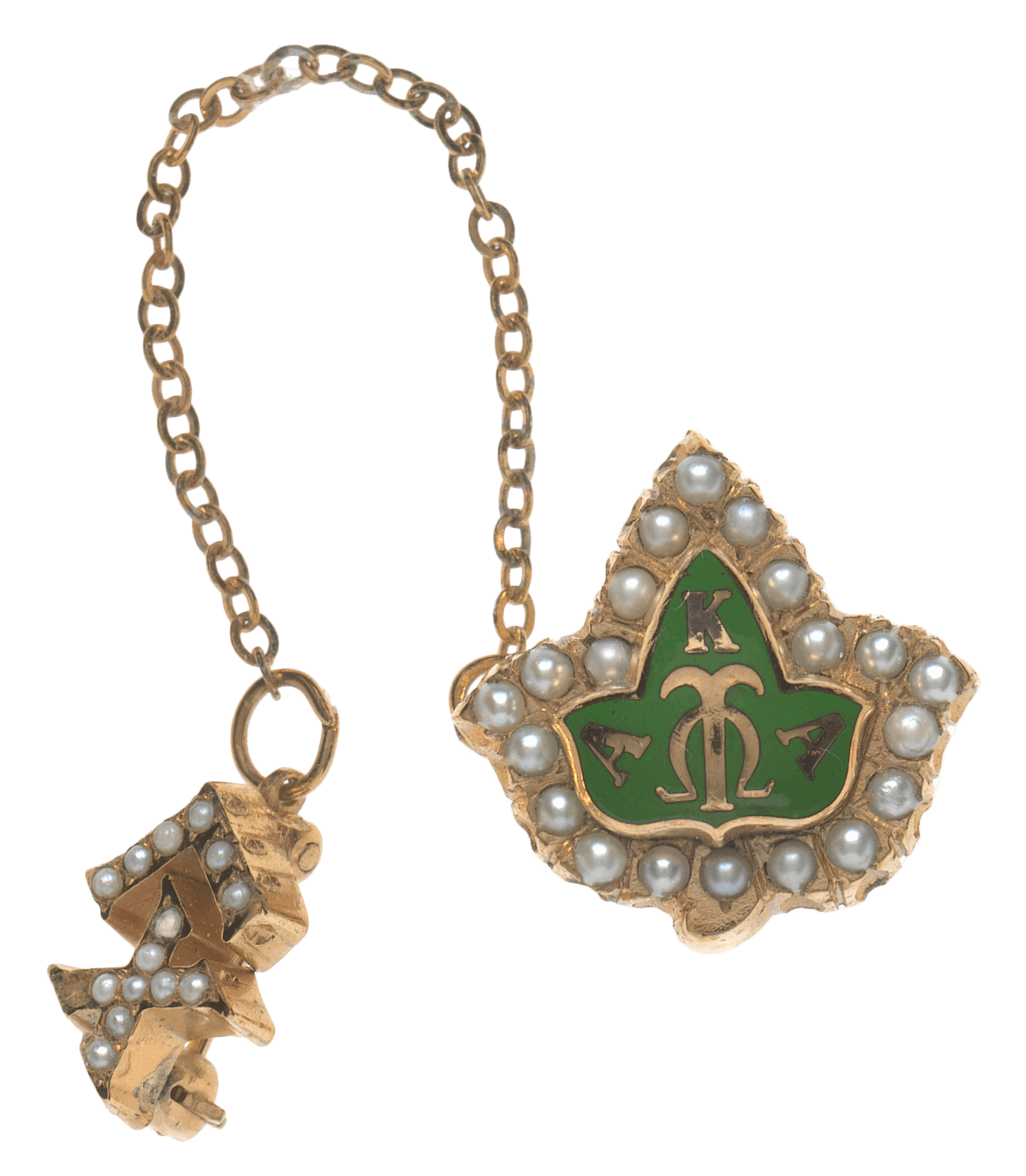 An Alpha Kappa Alpha members badge with a stickpin back. The badge is in the shape of an ivy leaf with a green center.