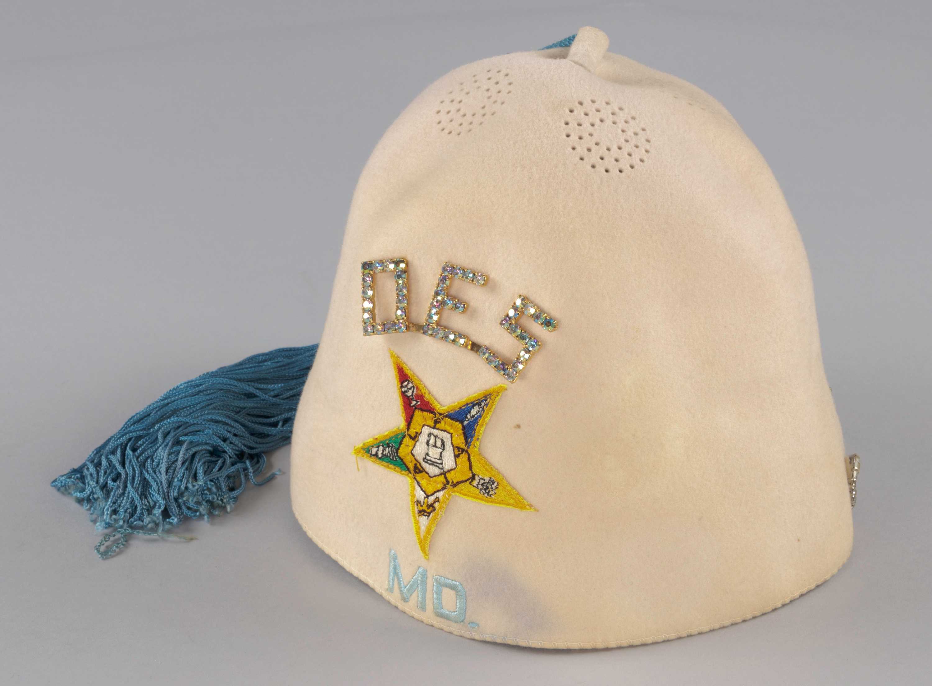 This cream felt fez hat was worn by a member of the Maryland Order of the Eastern Star.