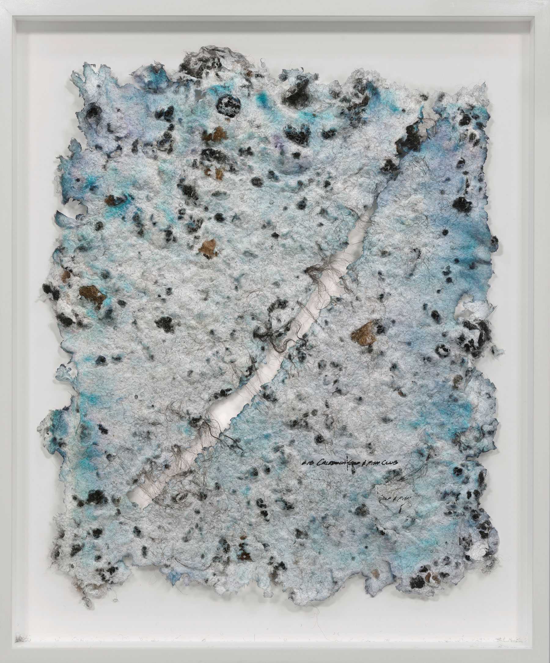 Framed abstract artwork with textured, torn paper featuring blue, black, and brown spots, and a vertical seam down the center.