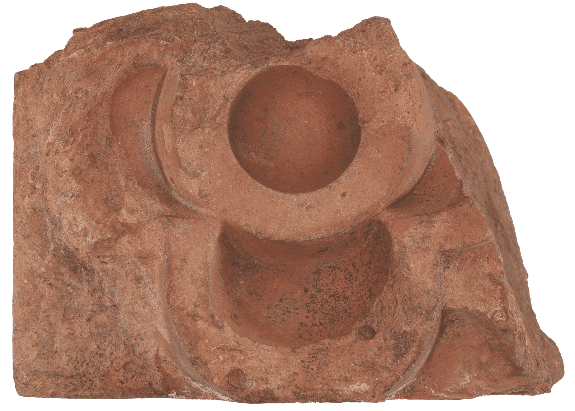 Terracotta colored brick fragment with an ornamental design.
