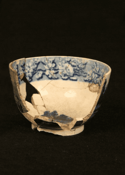 Photograph of ceramic cup and two shards