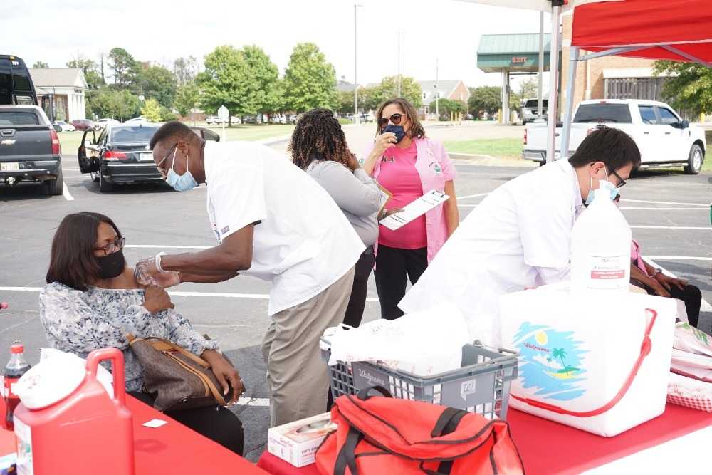 Photograph of doctor administering COVID vaccine