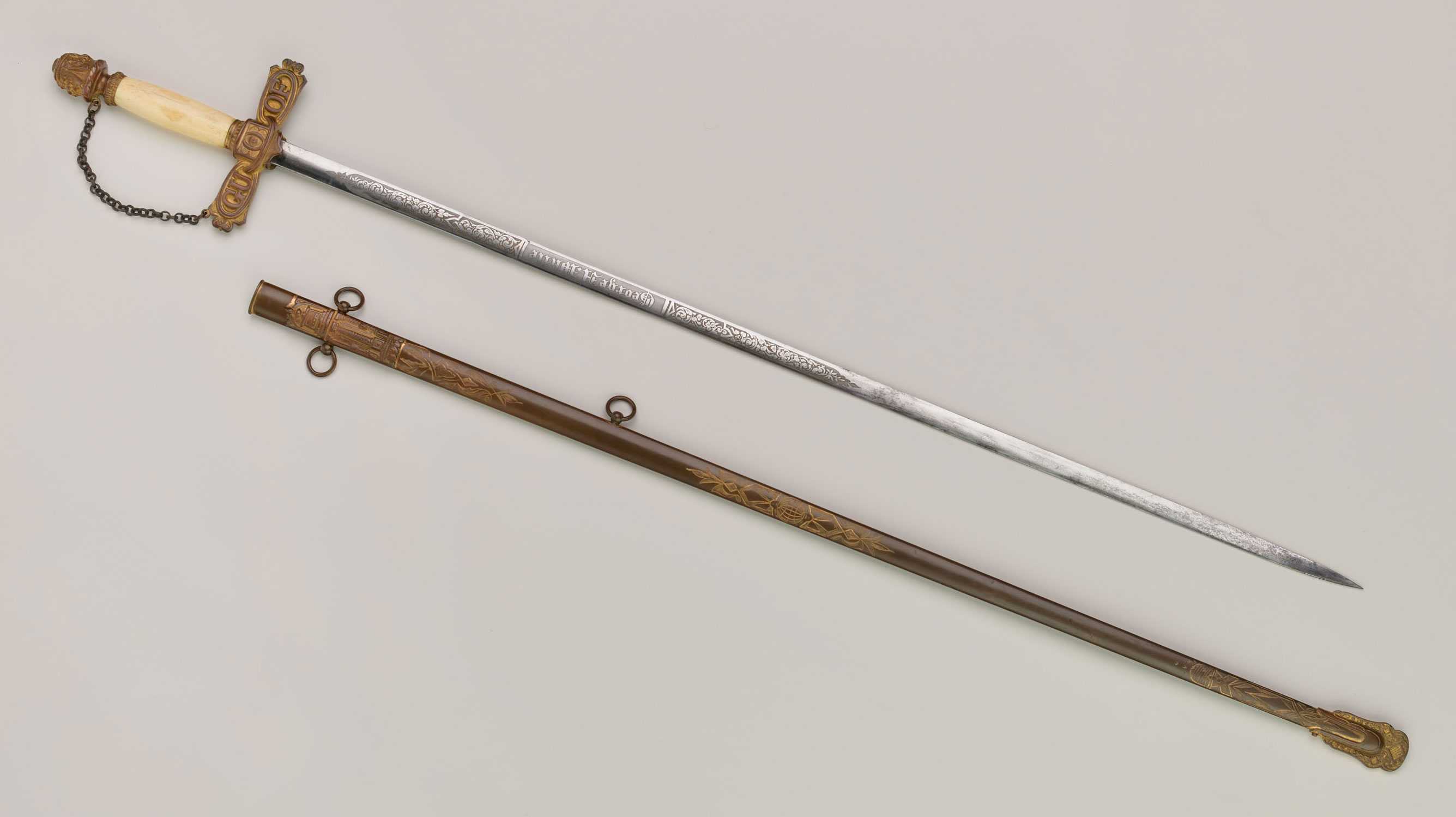 A thin sword and the protective scabbard. The handle of the sword as a chain connect.