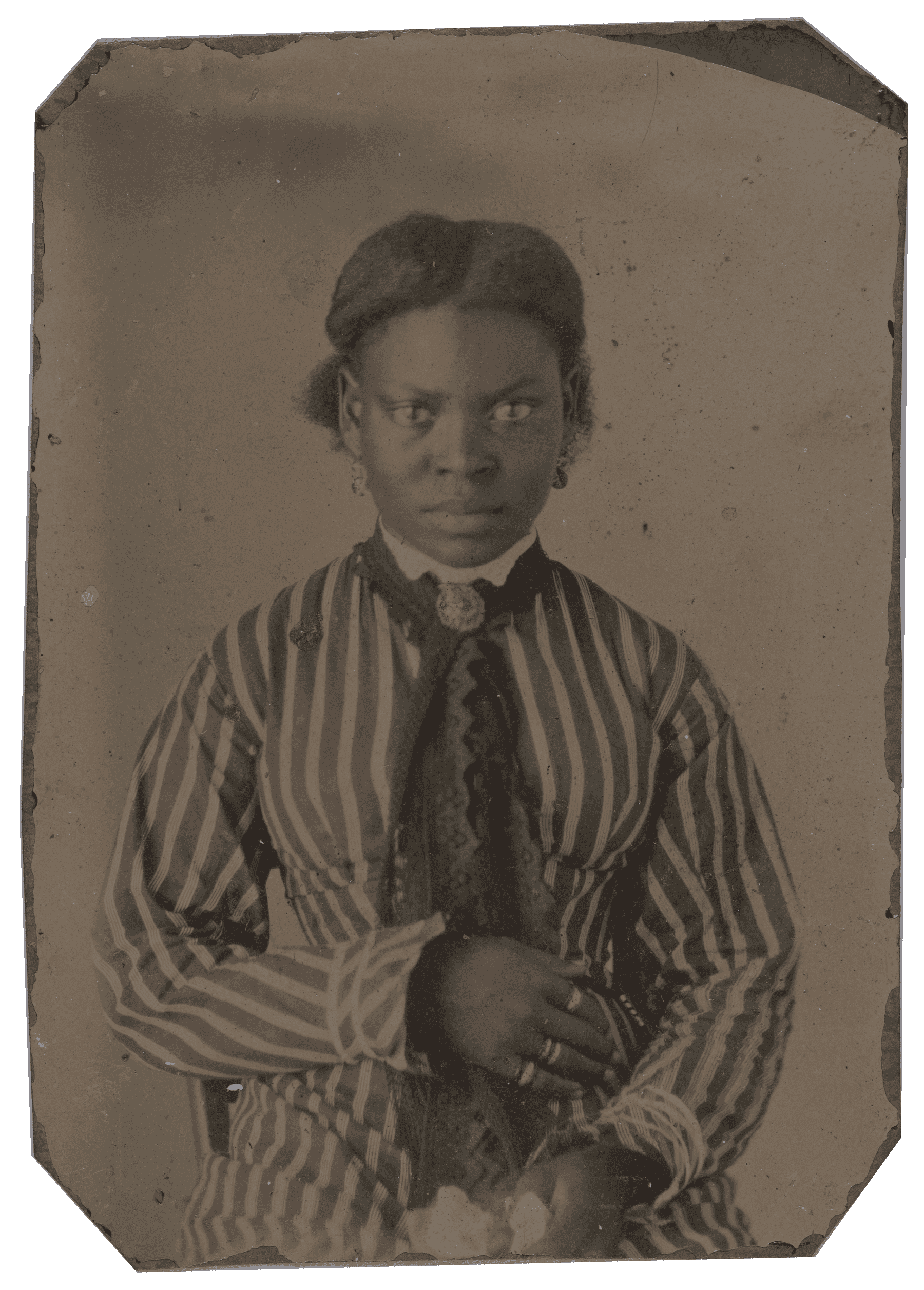 Tintype portrait of a woman in a striped dress seated with a serious expression.