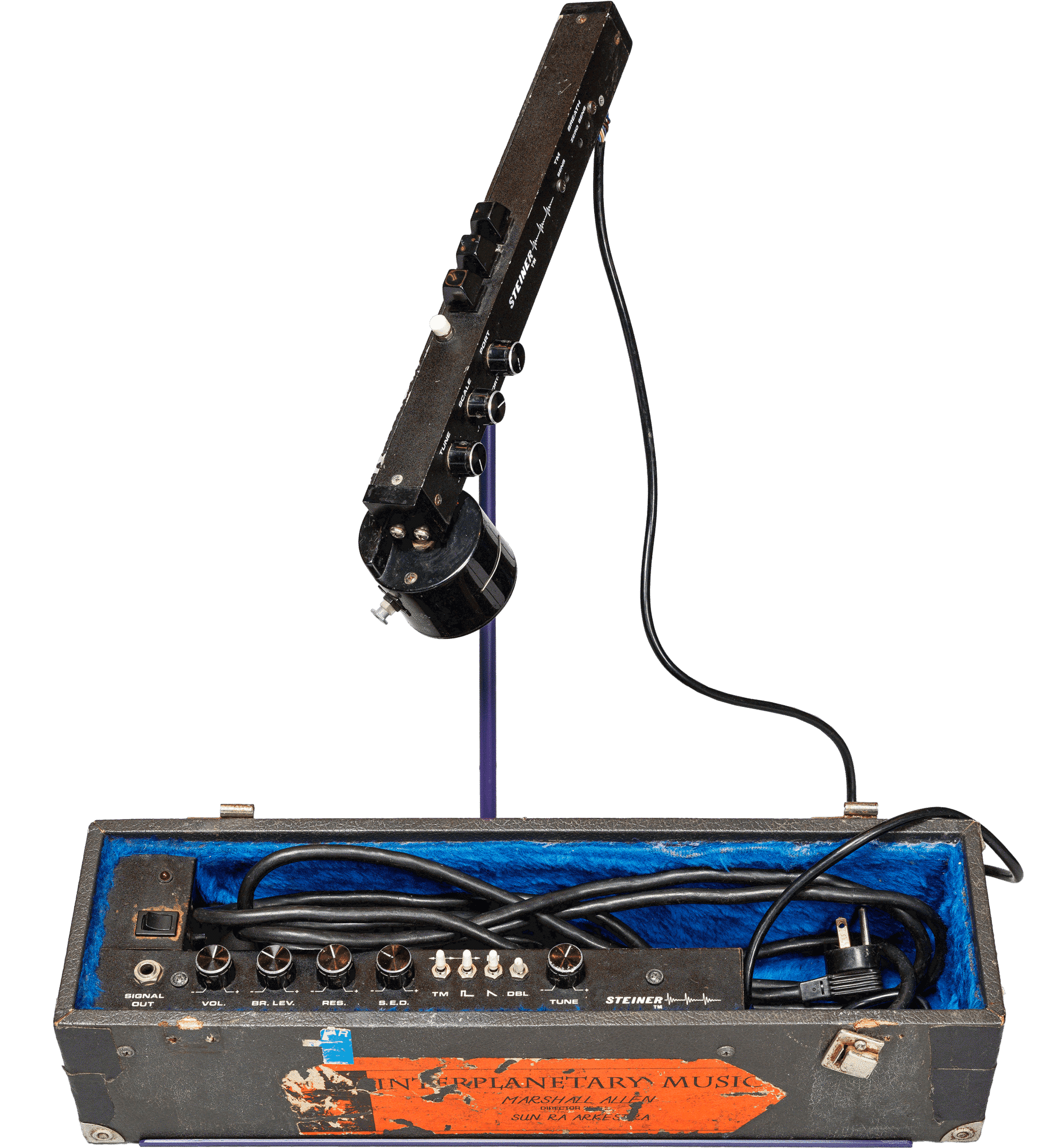 Electronic Valve Instrument looks like a mechanic microphone. It sits on top of a base with different gears and buttons.