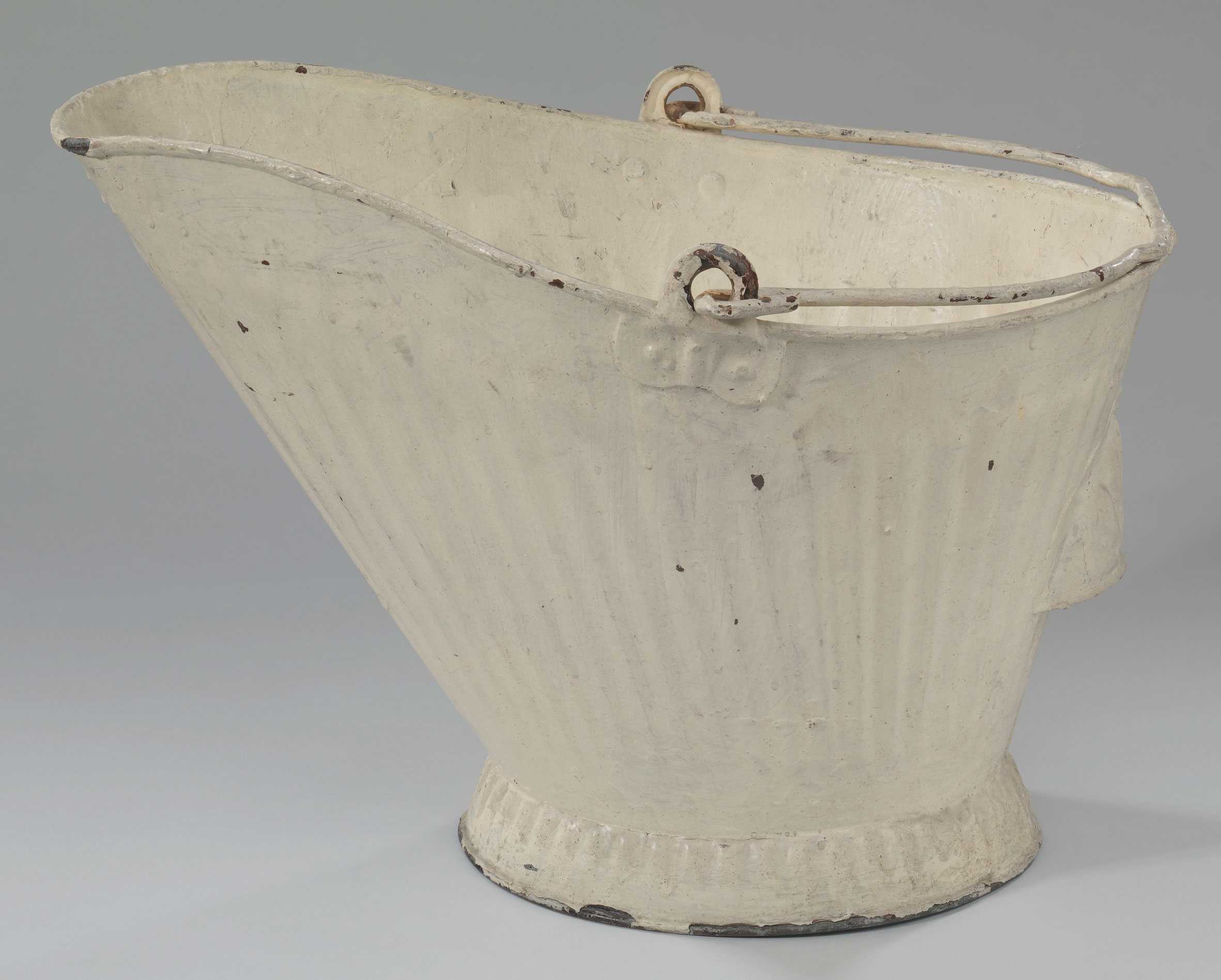 Ivory colored, metal coal scuttle with handle.