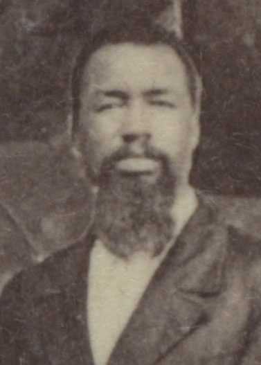 A blurry sepia tone photo of John A. Chestnut. He is wearing a suit and white dress shirt.