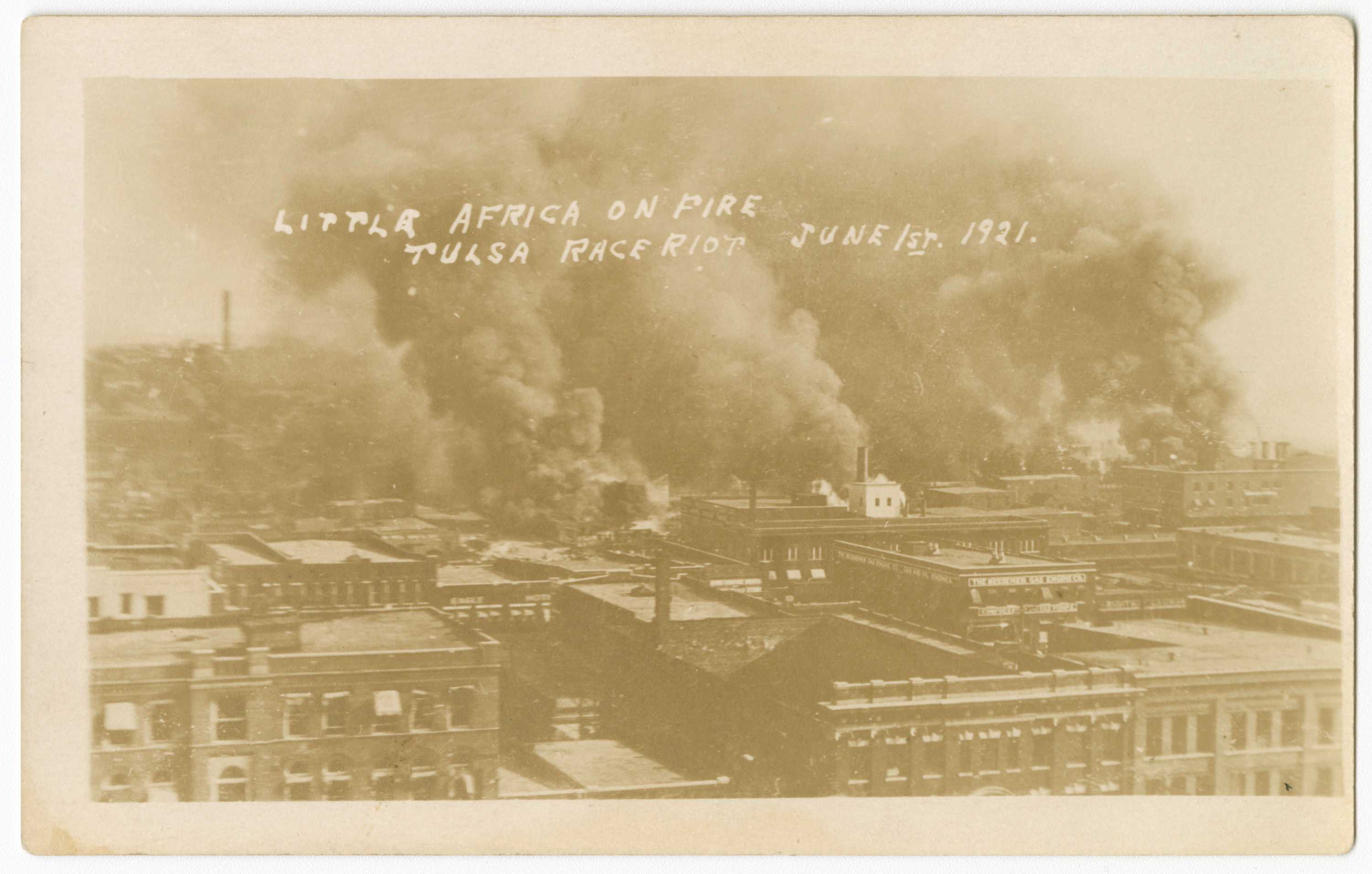 A sepia-toned photographic postcard depicting fires during the Tulsa Race Massacre.