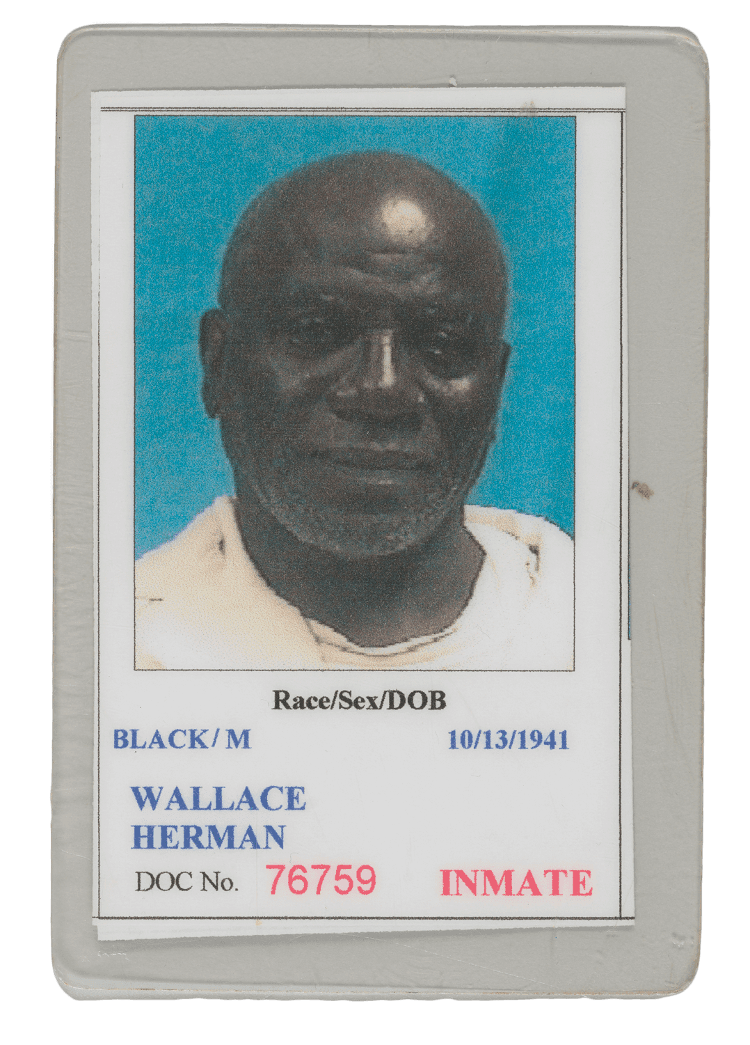 A prison badge with a large photo of Herman Wallace. It has his date, name, DOC No., race, and sex listed.