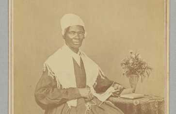 Cabinet card depicting Sojourner Truth seated, wearing a dark dress and a white shawl and cap.