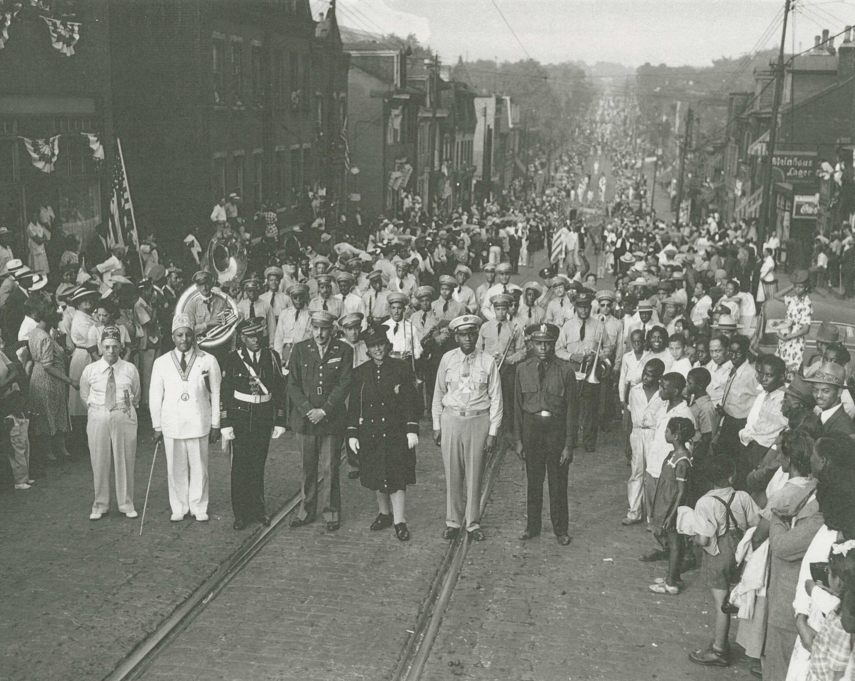 A black and white photograph of the annual Elks parade procession on the second hill of Wylie Avenue in Pittsburgh's Hill District.