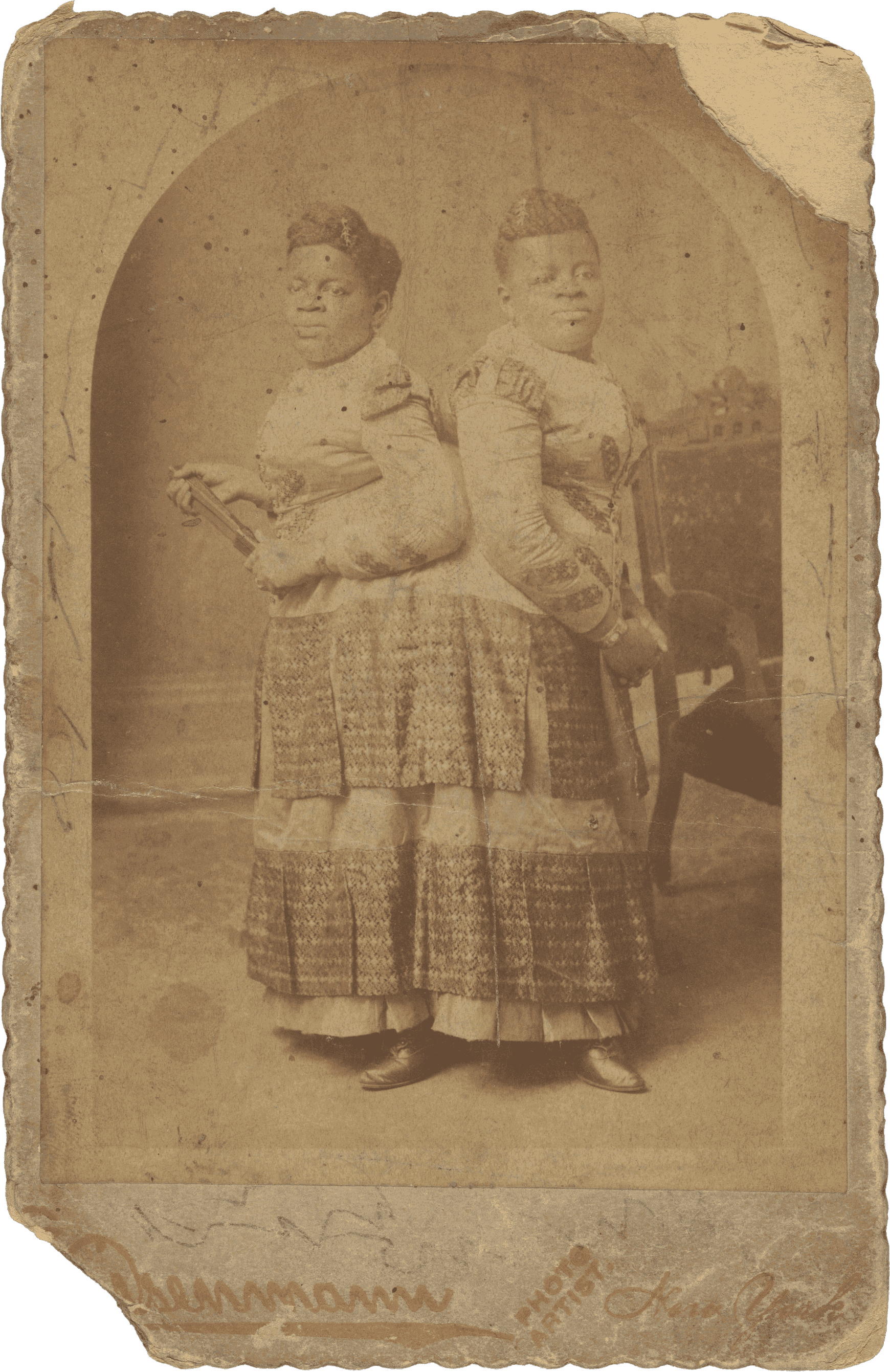 Image of a photograph of conjoined women Millie and Christine McCoy. The photograph is around the edges.