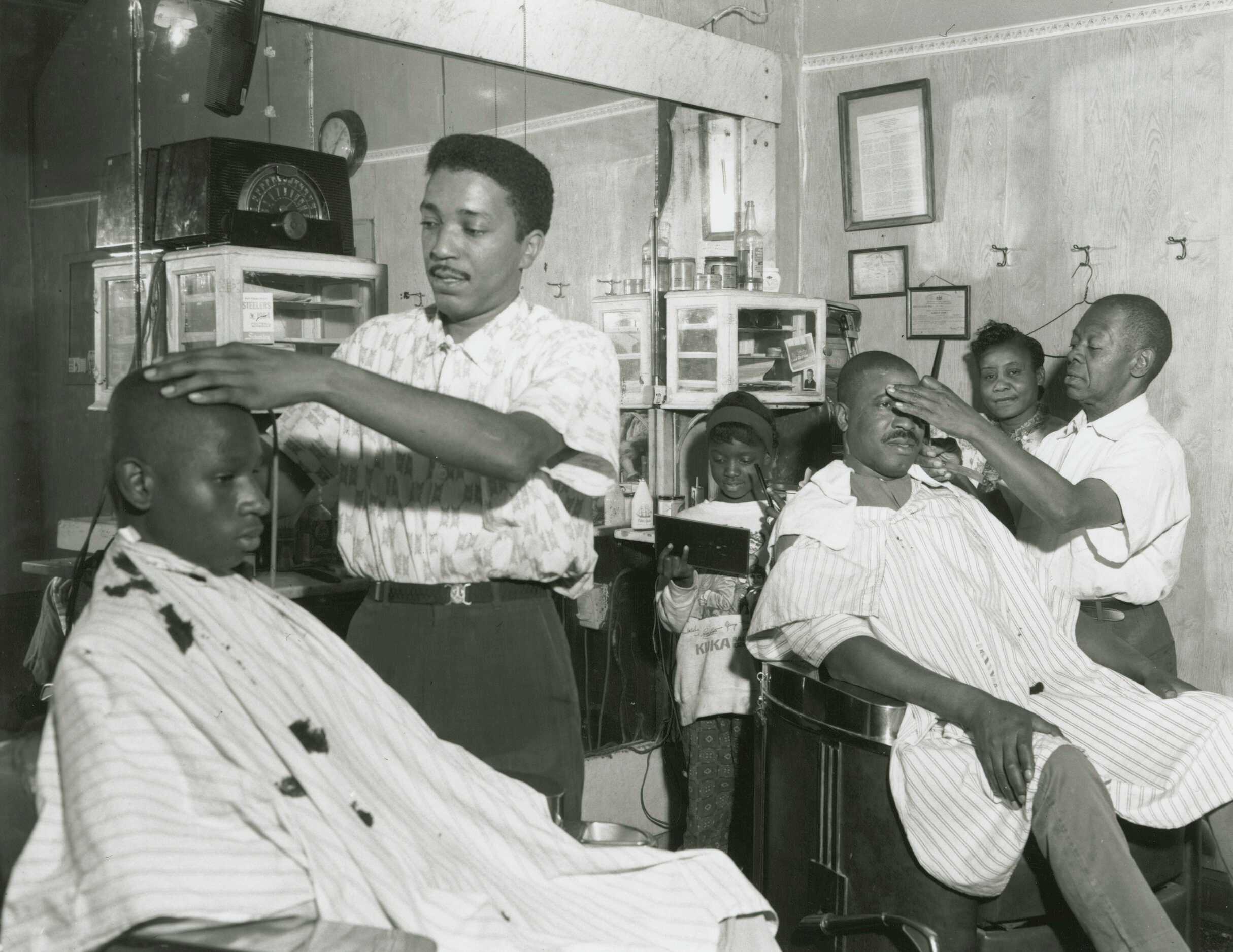 A black and white photograph of Johnny Gator's barbershop.