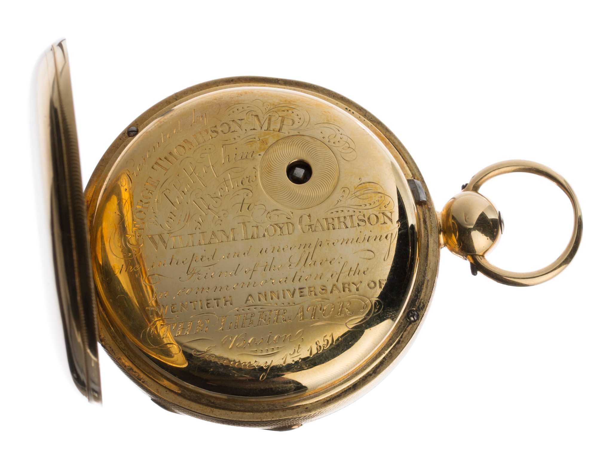 An inscribed gold pocket watch presented to William Lloyd Garrison. The watch has a half hunter case, with spring hinged glass cover over the dial and a hinged gold lid over the back, protecting the inscription and winding square. The dial is painted white with roman numerals and fleur de lis shaped watch hands. There is a smaller 60-second dial partly obscuring the "VI" of the larger dial. The two hinged covers open via a button on the crown and bow, positioned above the "XII" of the dial. The engraved inscription on the back of the watch is decorative and reads [Presented by / GEORGE THOMPSON, M.P. / on behalf of him / self and others / to / WILLIAM LLOYD GARRISON, / intrepid and uncompromising / Friend of the Slave: / in commemoration of the / TWENTIETH ANNIVERSARY OF / THE LIBERATOR / Boston / January 1st, 1851] in several text sizes and fonts. Production and identification marks are stamped and scratched on the inside of the back cover.