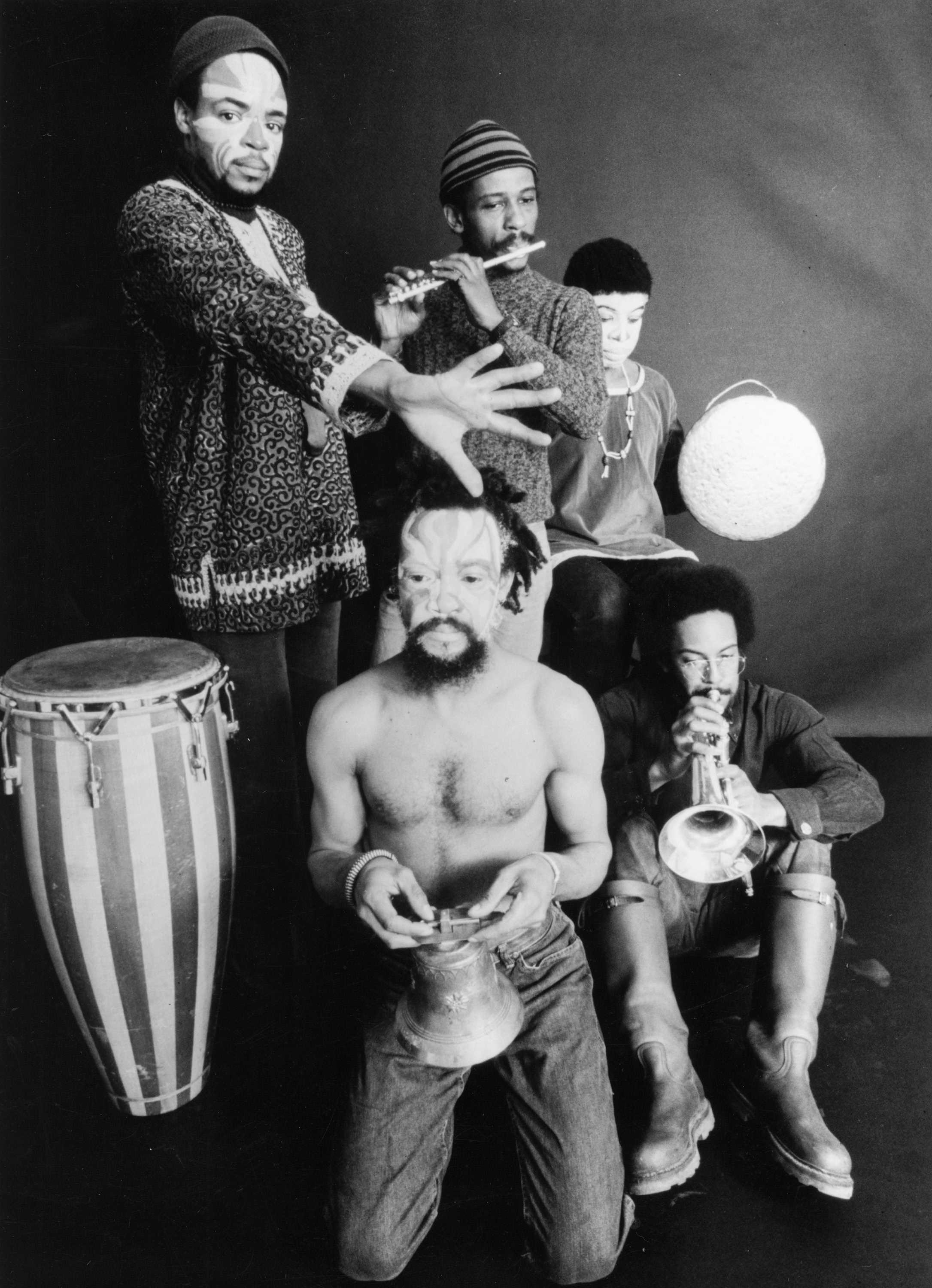A black and white portrait of the band The Art Ensemble of Chicago. Each posed with their instruments in different postures.